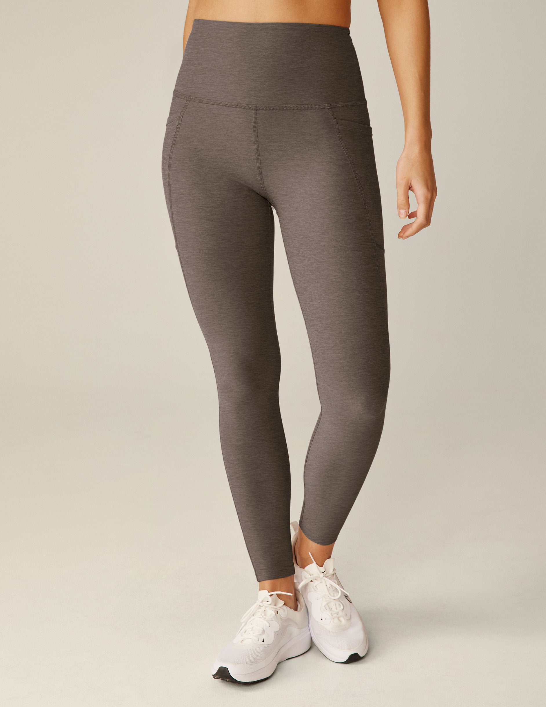 brown high-waisted midi leggings with pockets.