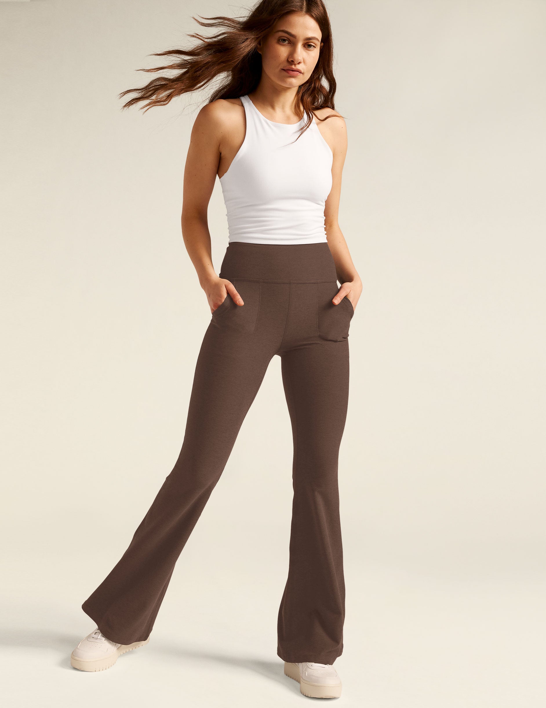 brown high-waisted flare pants with front side pockets. 