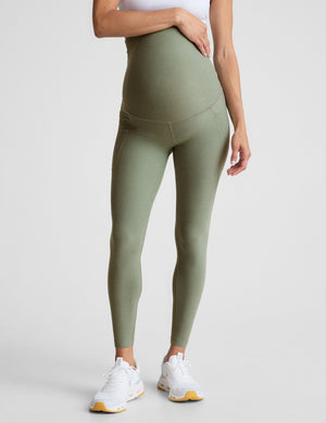 green high-waisted maternity leggings with pockets.