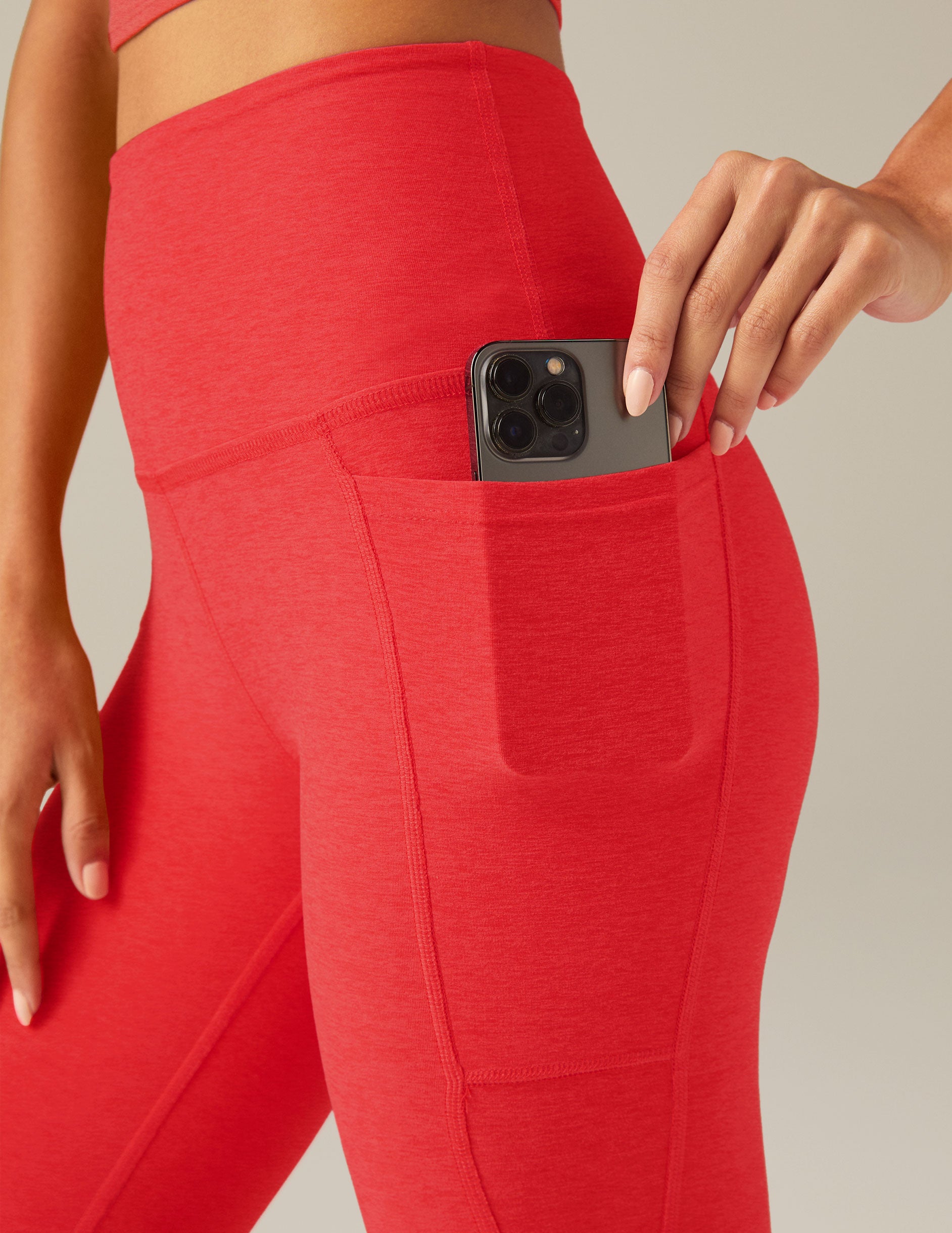 red high-waisted midi leggings with pockets. 