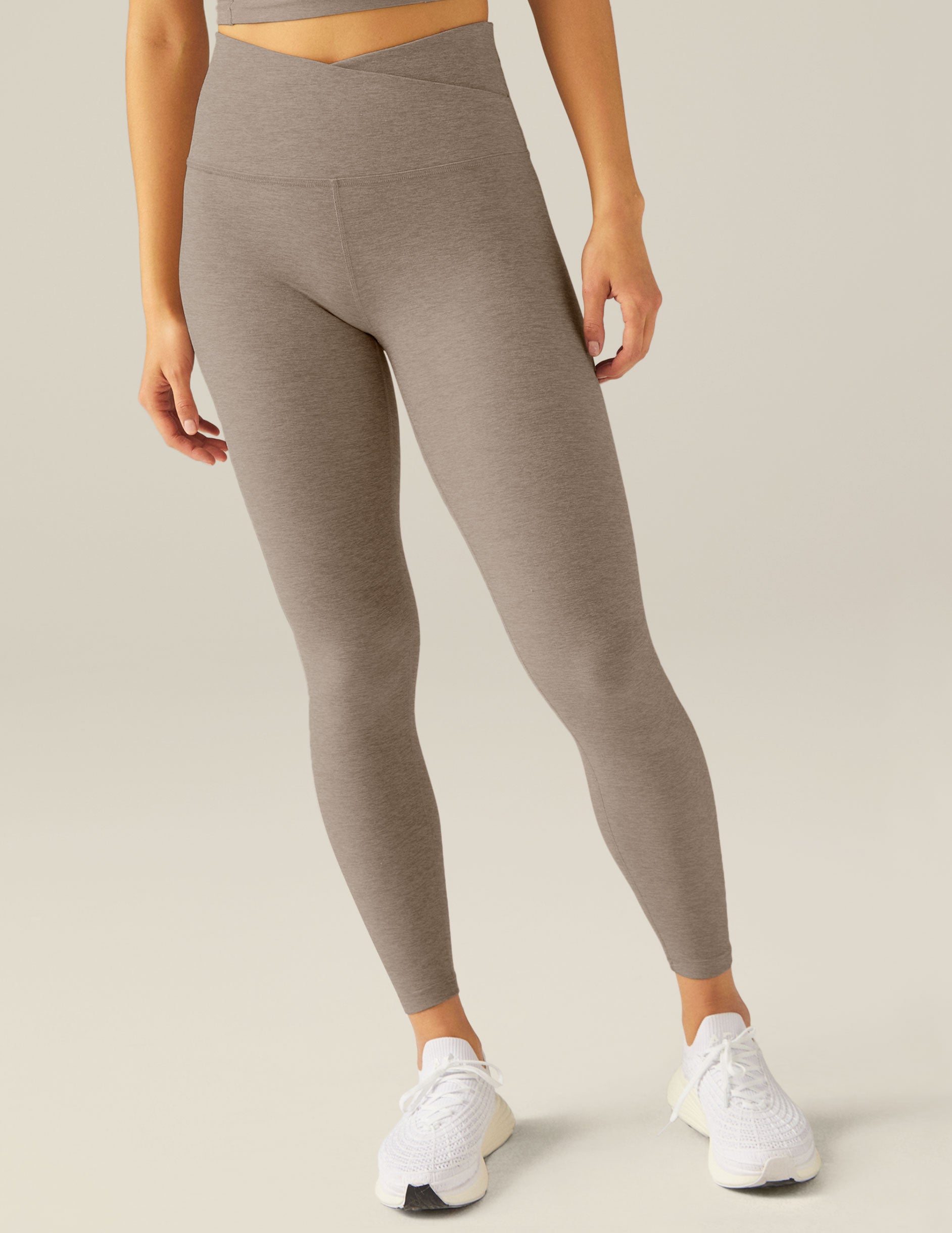 brown high-waisted midi leggings with a front crossover waistband. 