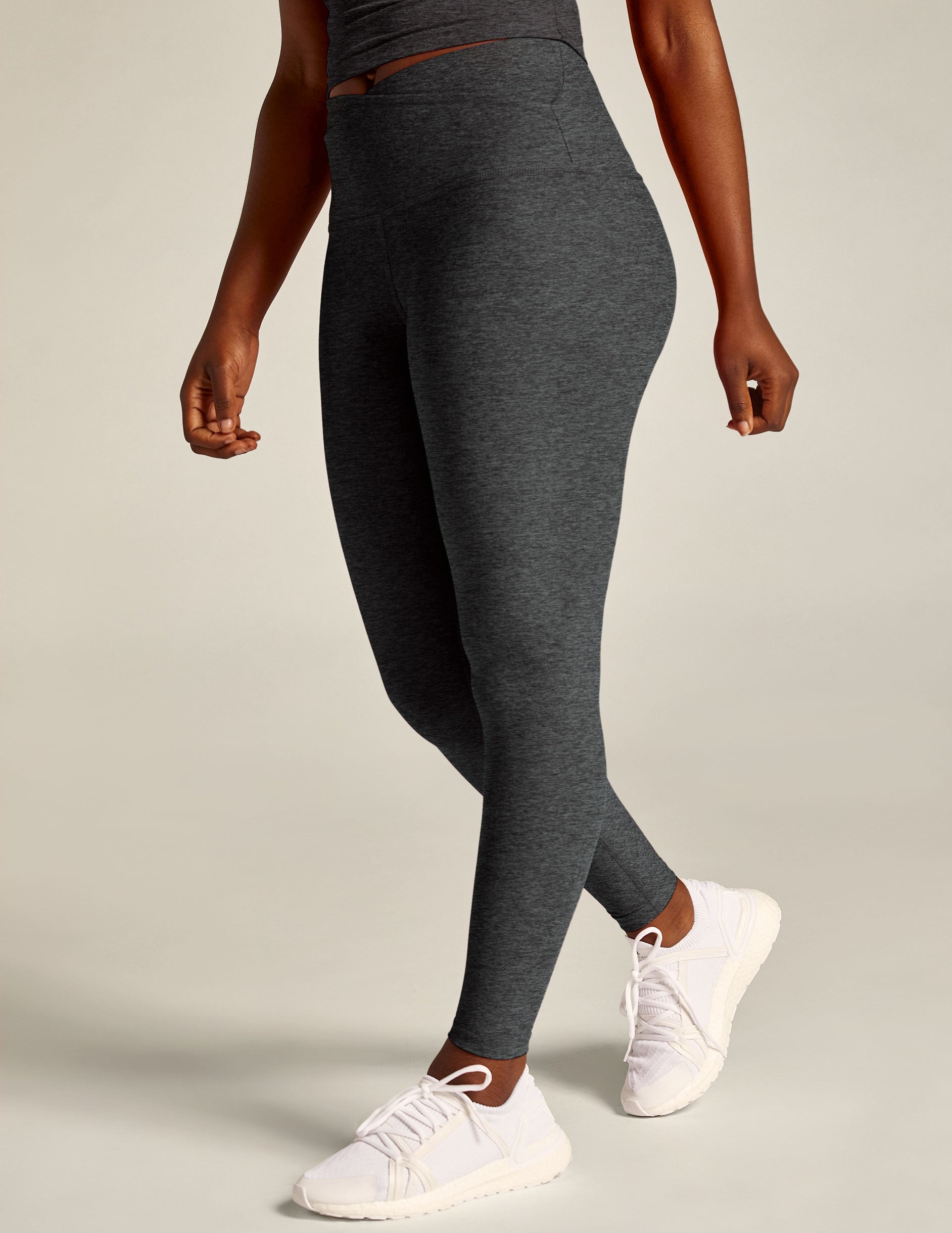 black-charcoal high-waisted midi legging with a crossover detail on the front waistband. 