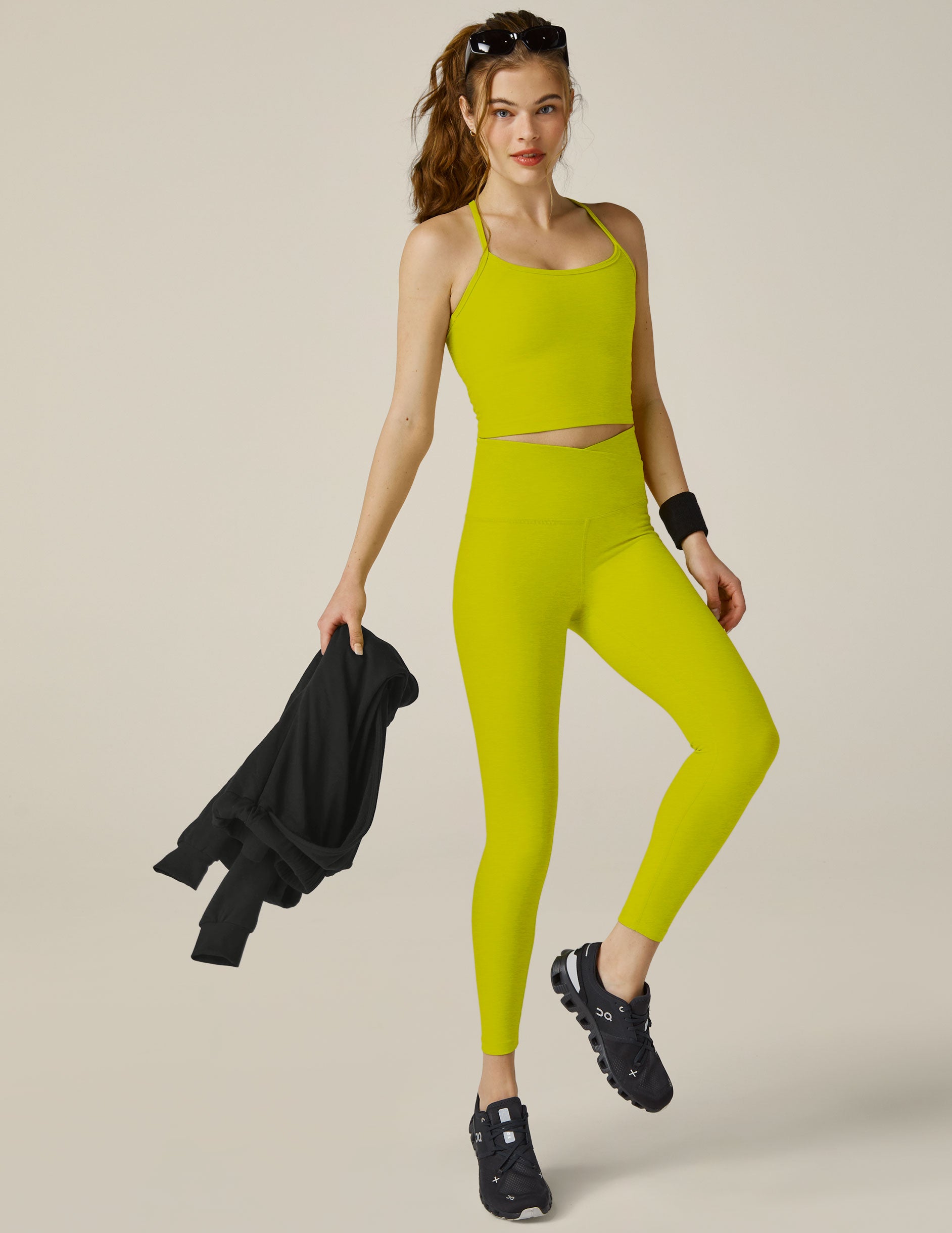 green midi leggings with crossover design on waistband