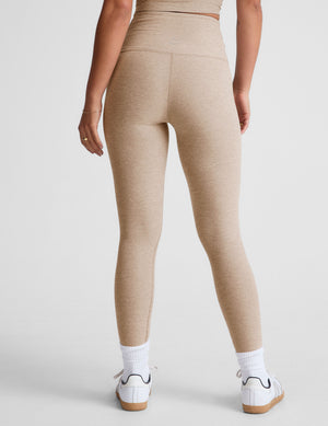 brown high-waisted midi length leggings with a crossover detail on the front waistband.