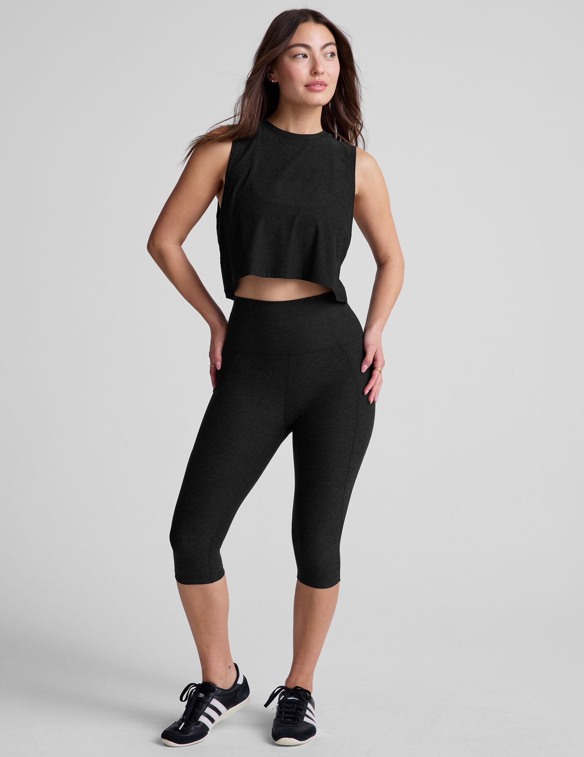 black high-waisted pedal pusher length leggings with pockets.