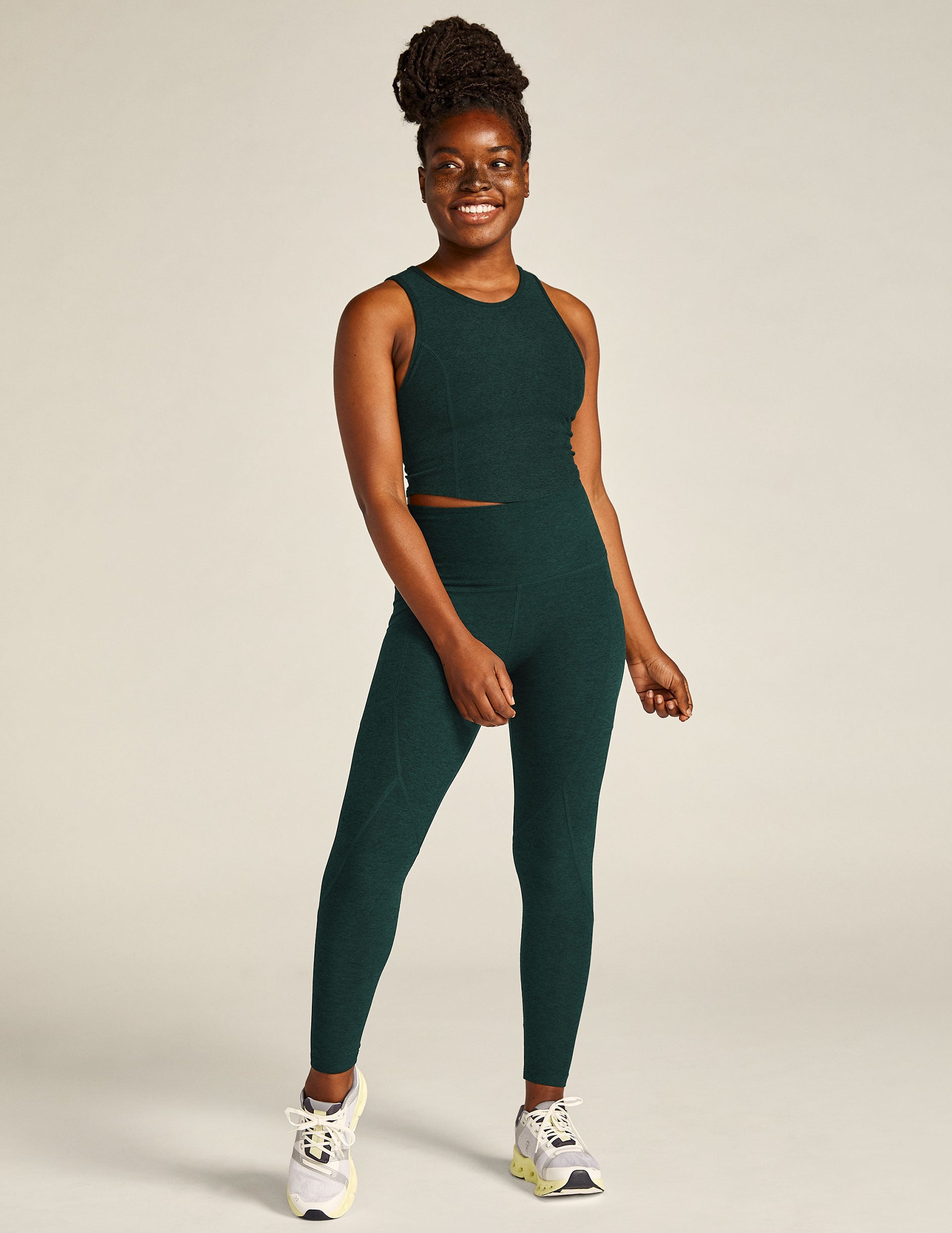 green high-waisted midi leggings with a side pocket. 