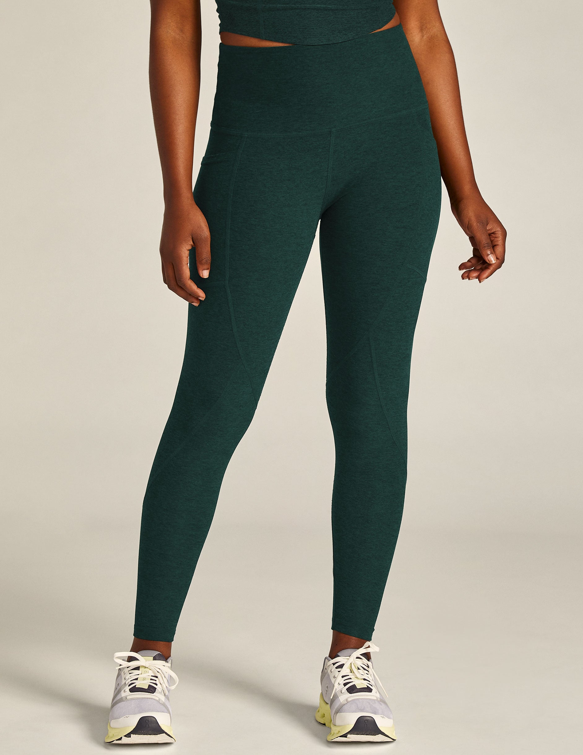 green high-waisted midi leggings with a side pocket. 
