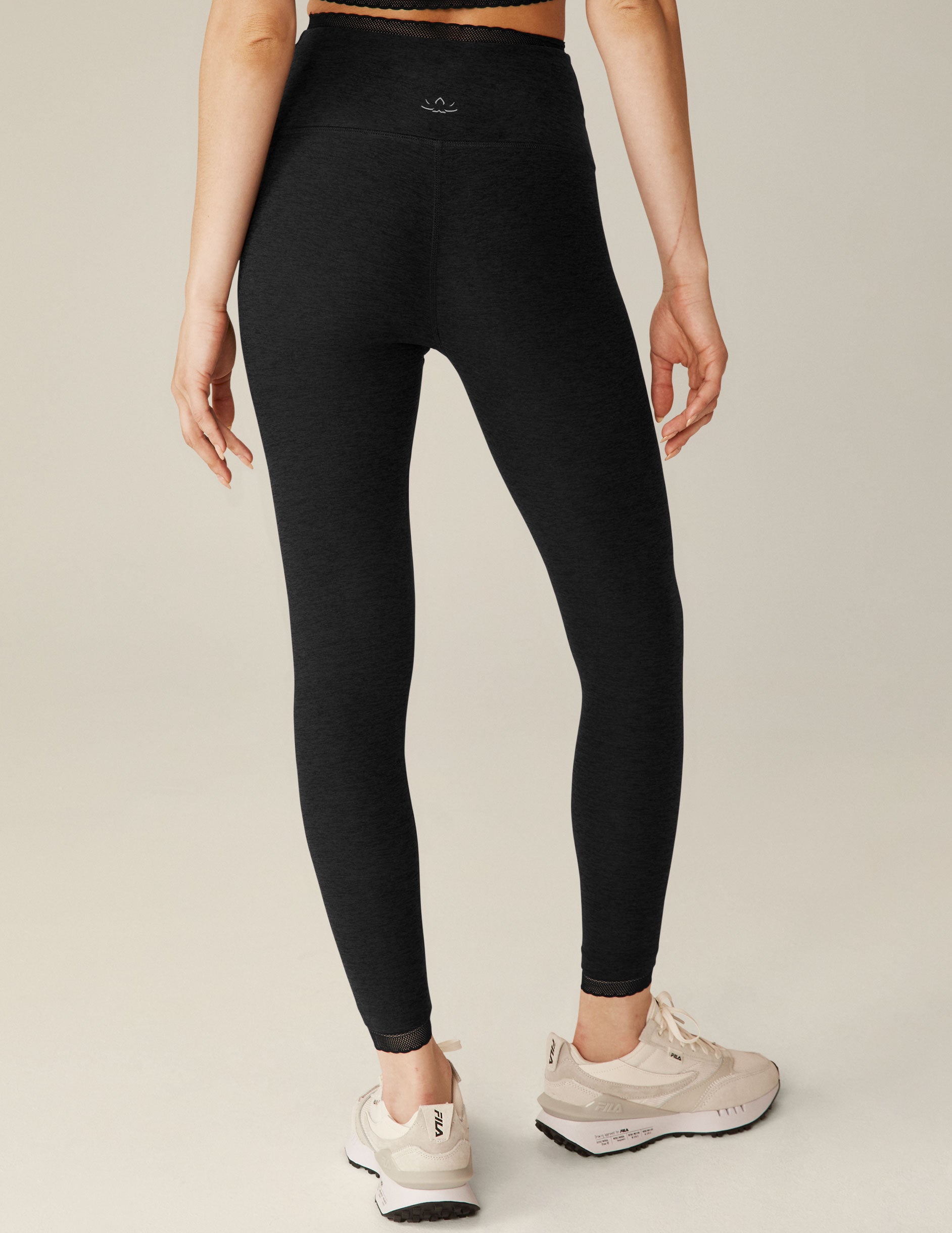 black high-waisted midi leggings with a lace trim at waistband and ankles. 