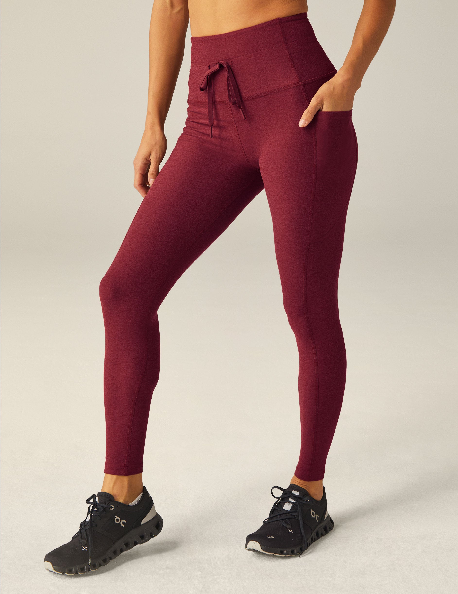 red waisted midi leggings with a drawstring at the waistband and side pockets.