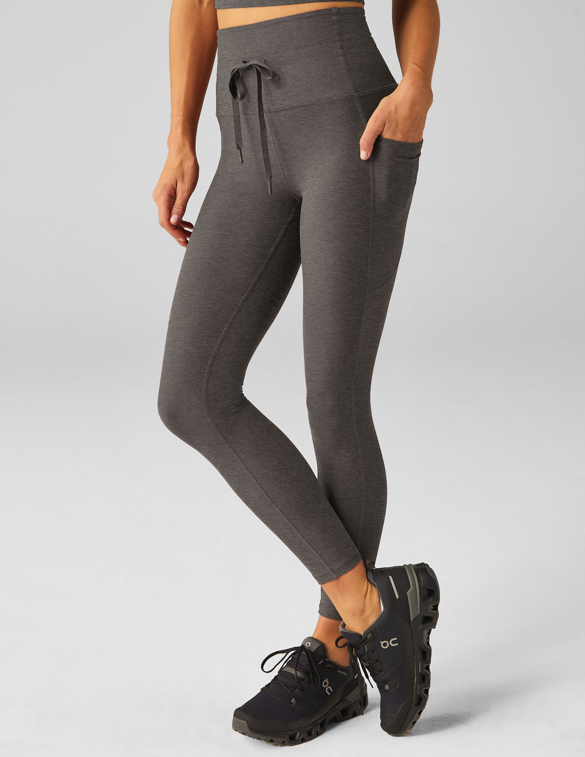 gray high-waisted midi length leggings with side pockets and a drawstring on front waistband.