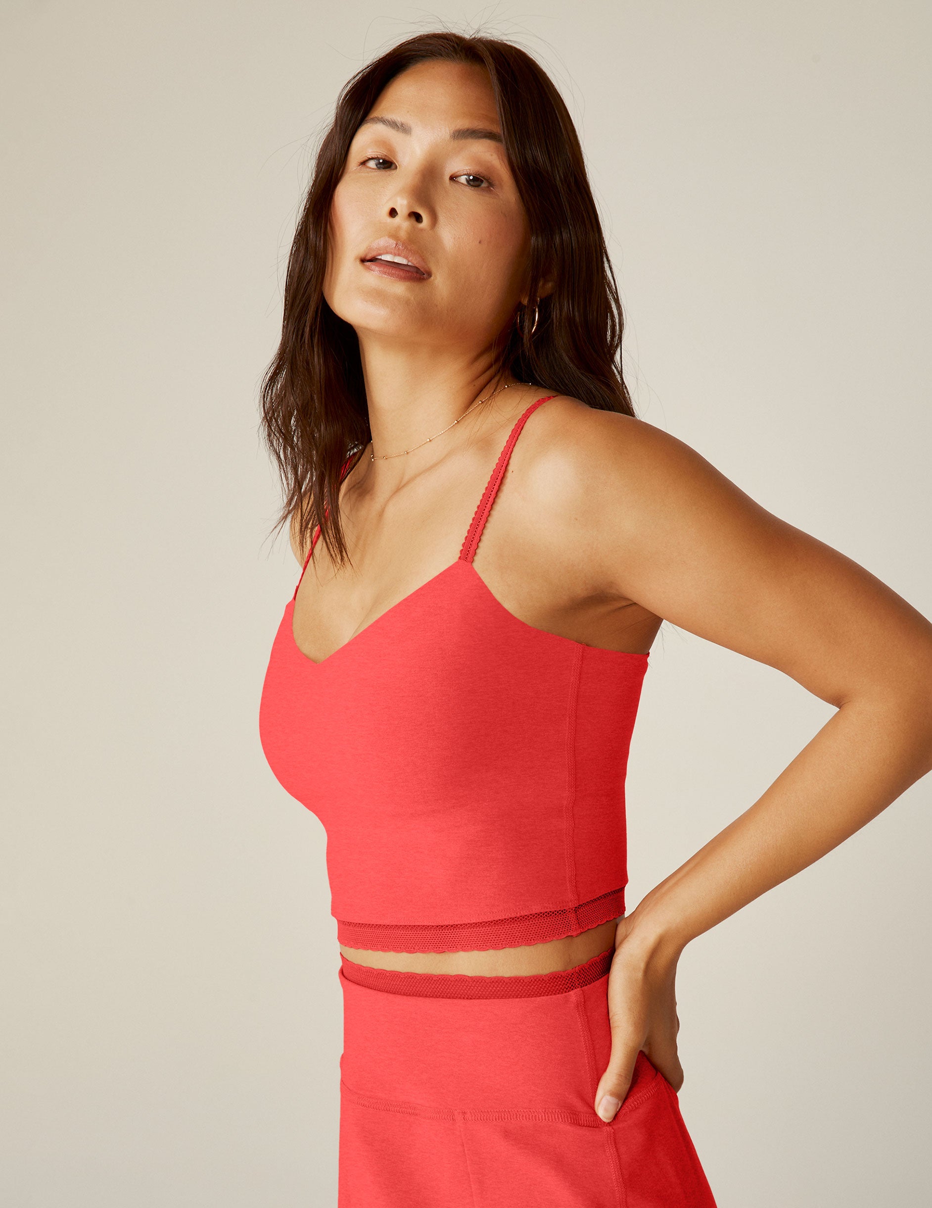 red v-neck slim strap cropped tank with lace trim at the neckline and waistline.