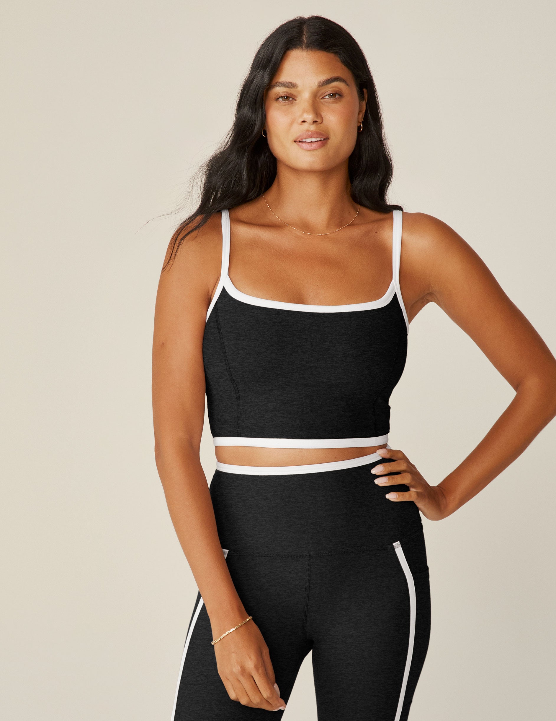 black cropped tank with white lining along neckline and waistline.