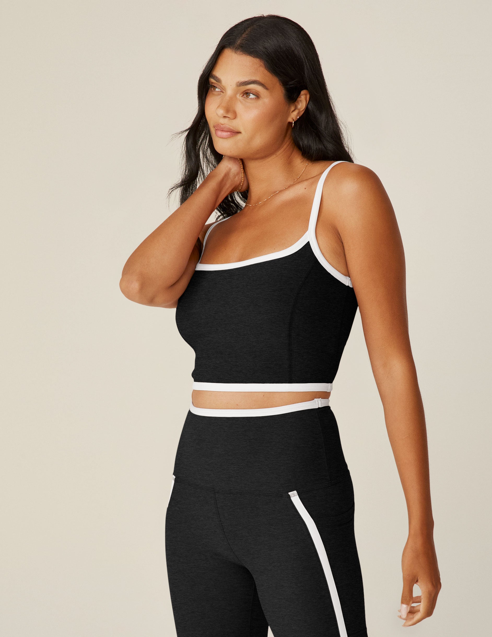 black cropped tank with white lining along neckline and waistline.