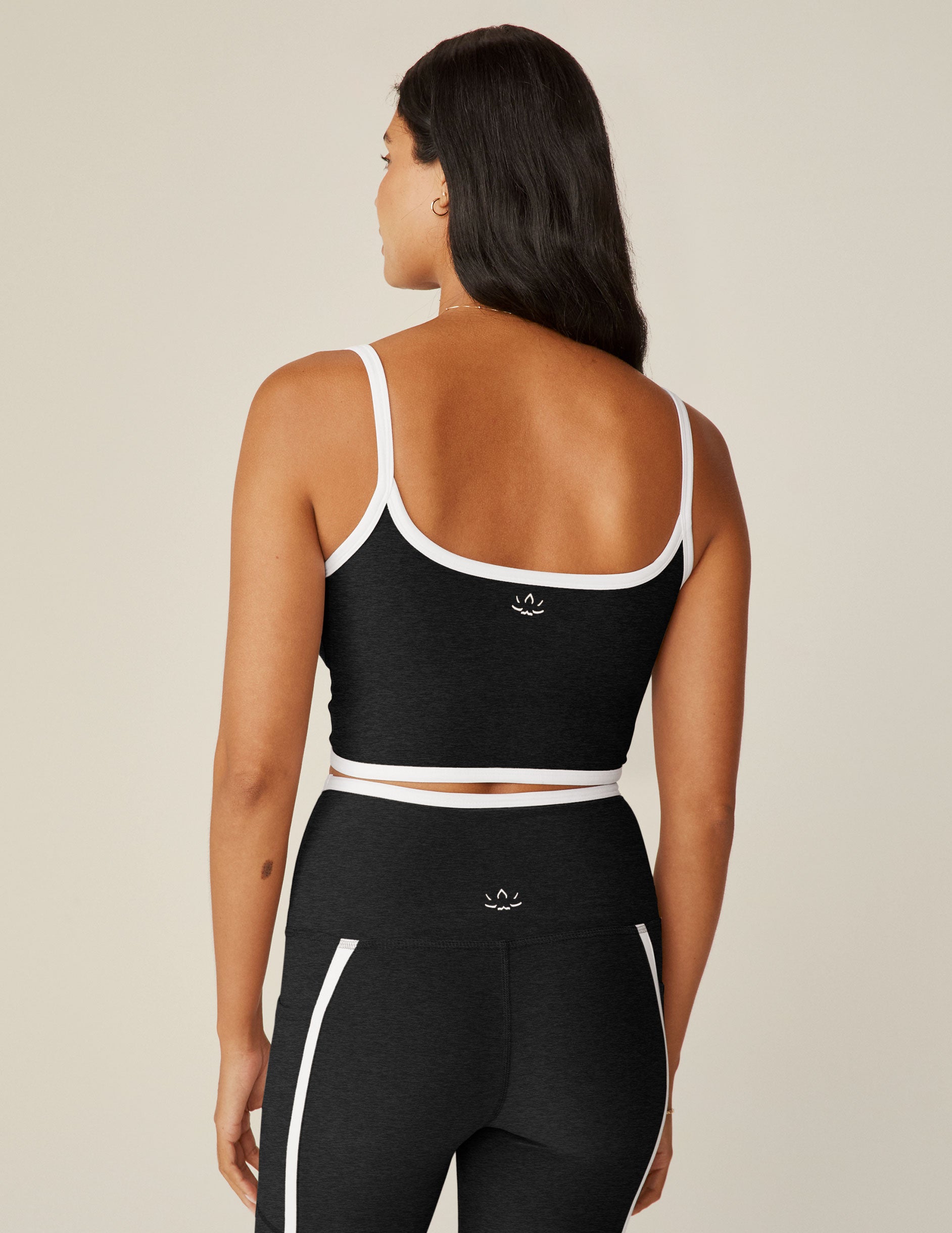 black cropped tank with white lining along neckline and waistline. 