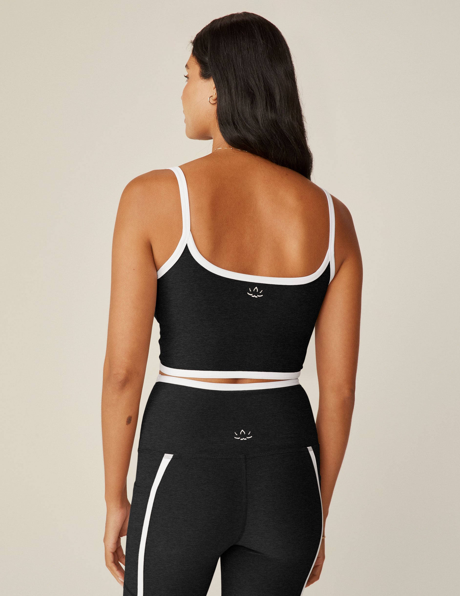 black cropped tank with white lining along neckline and waistline.