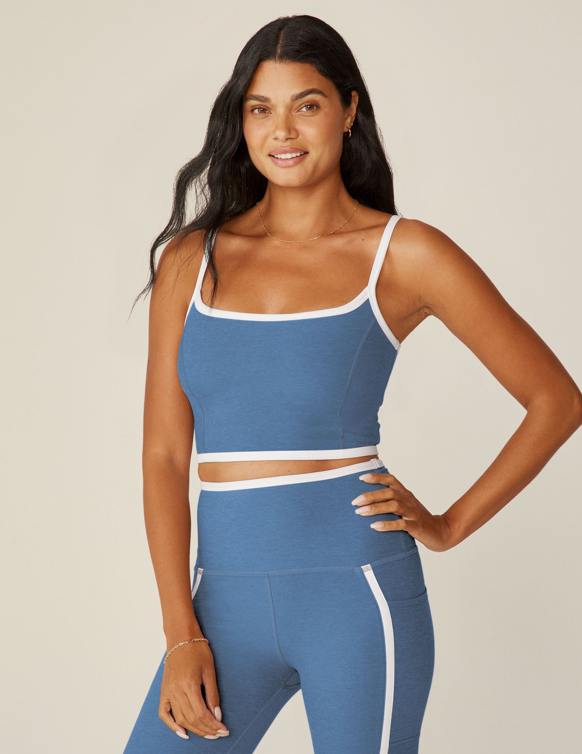 blue cropped tank top with white straps and lining around neckline and waistline. 