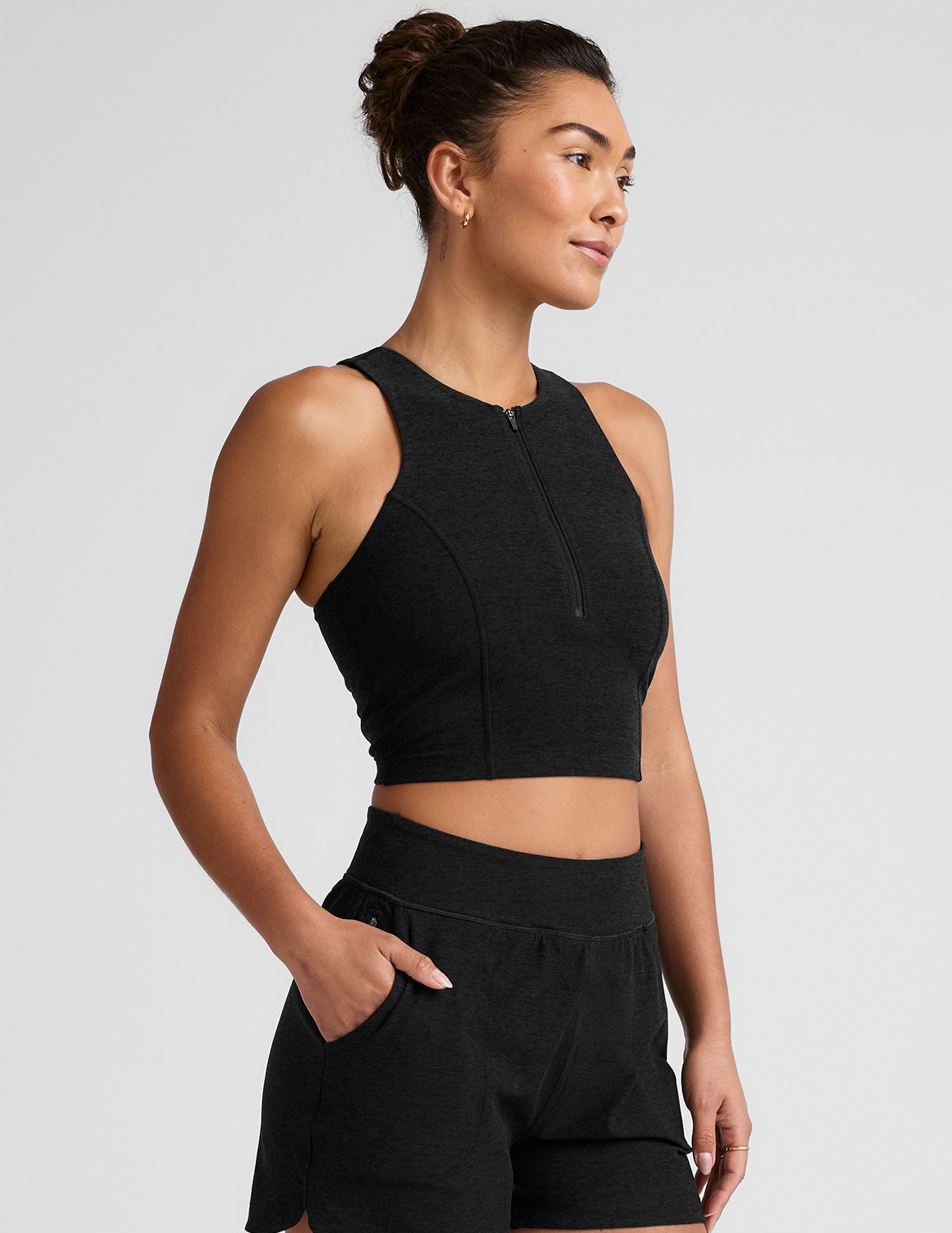 black cropped tank with a high neck with center front zipper.