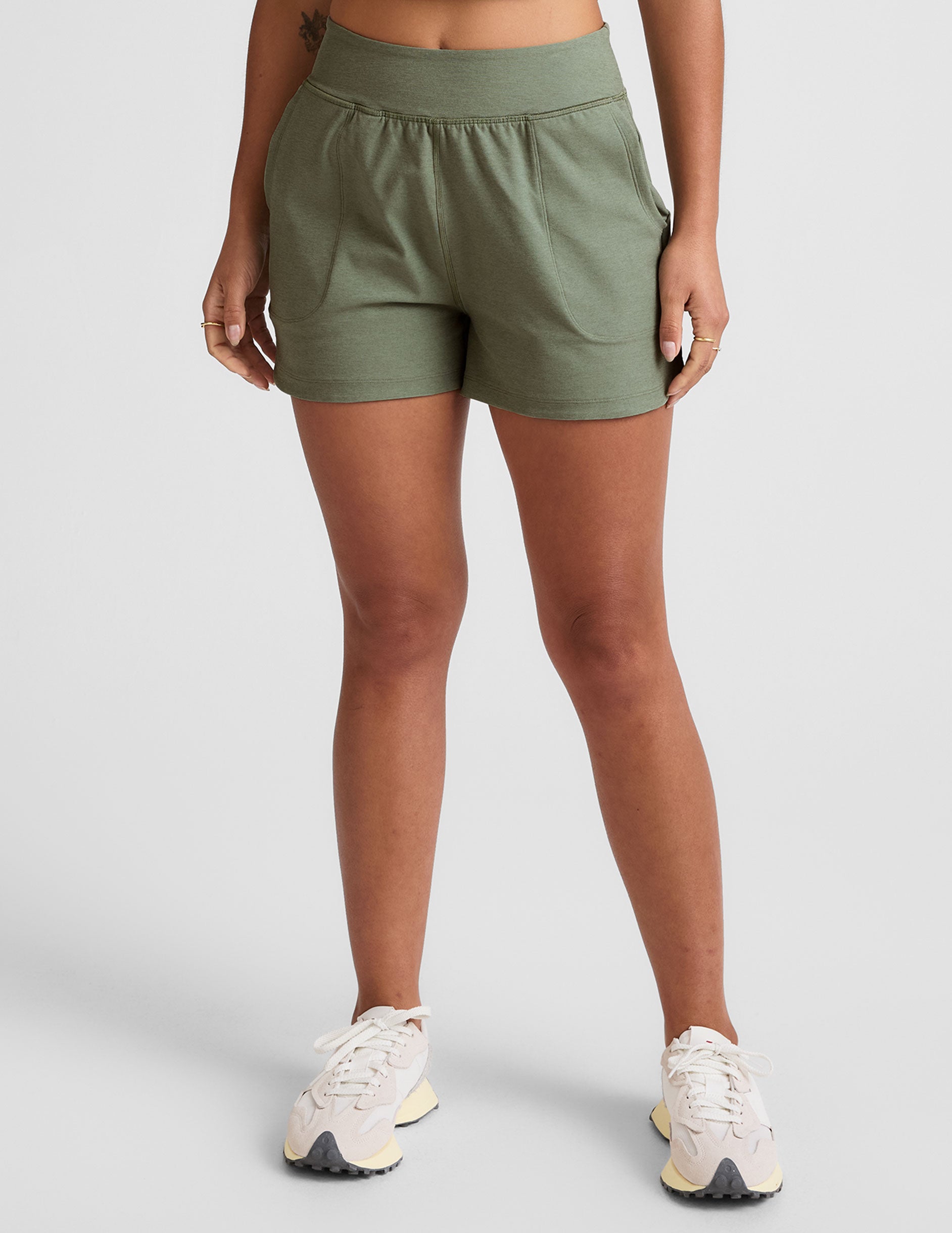 green mid-rise 3" inseam shorts with pockets.