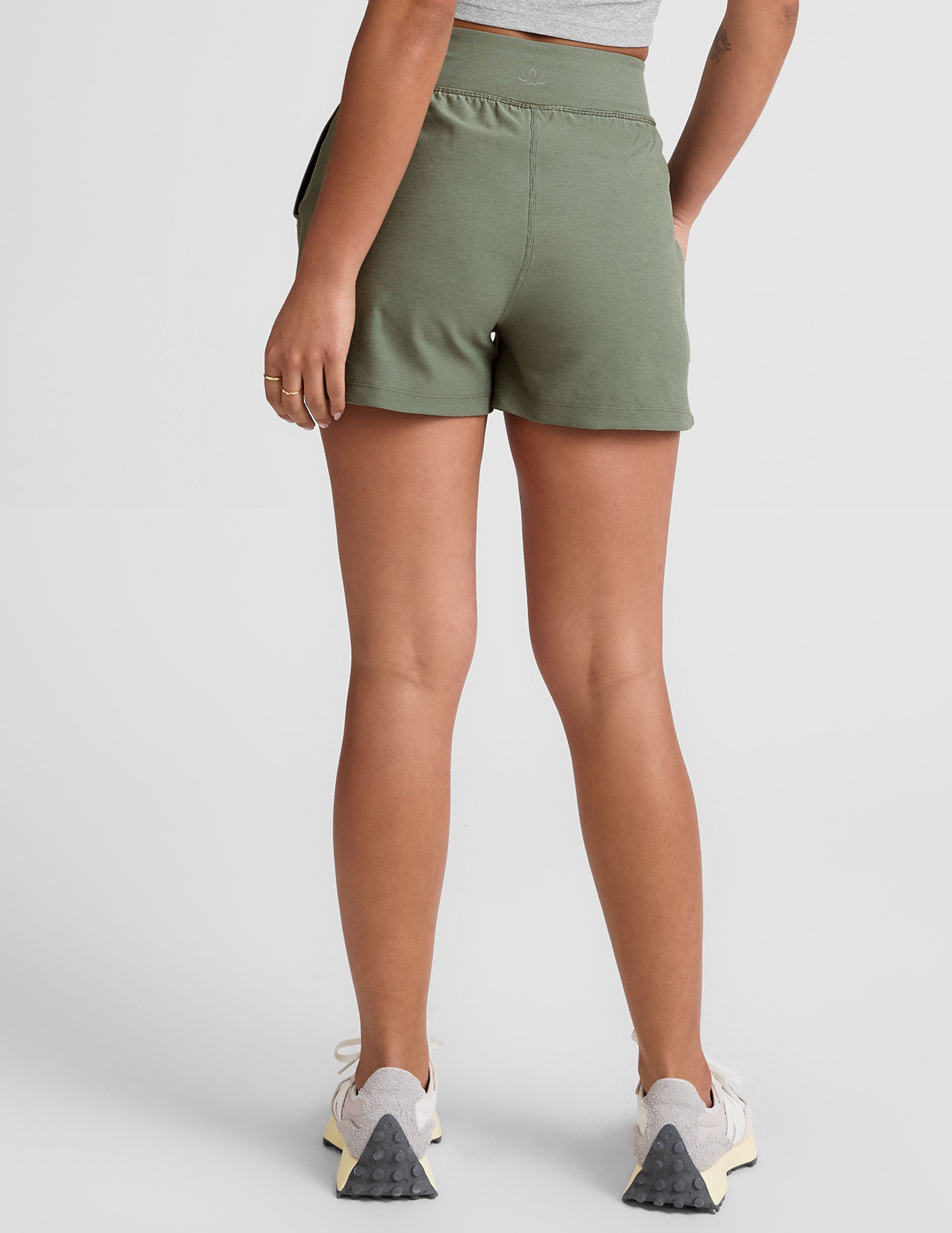 green mid-rise 3" inseam shorts with pockets.