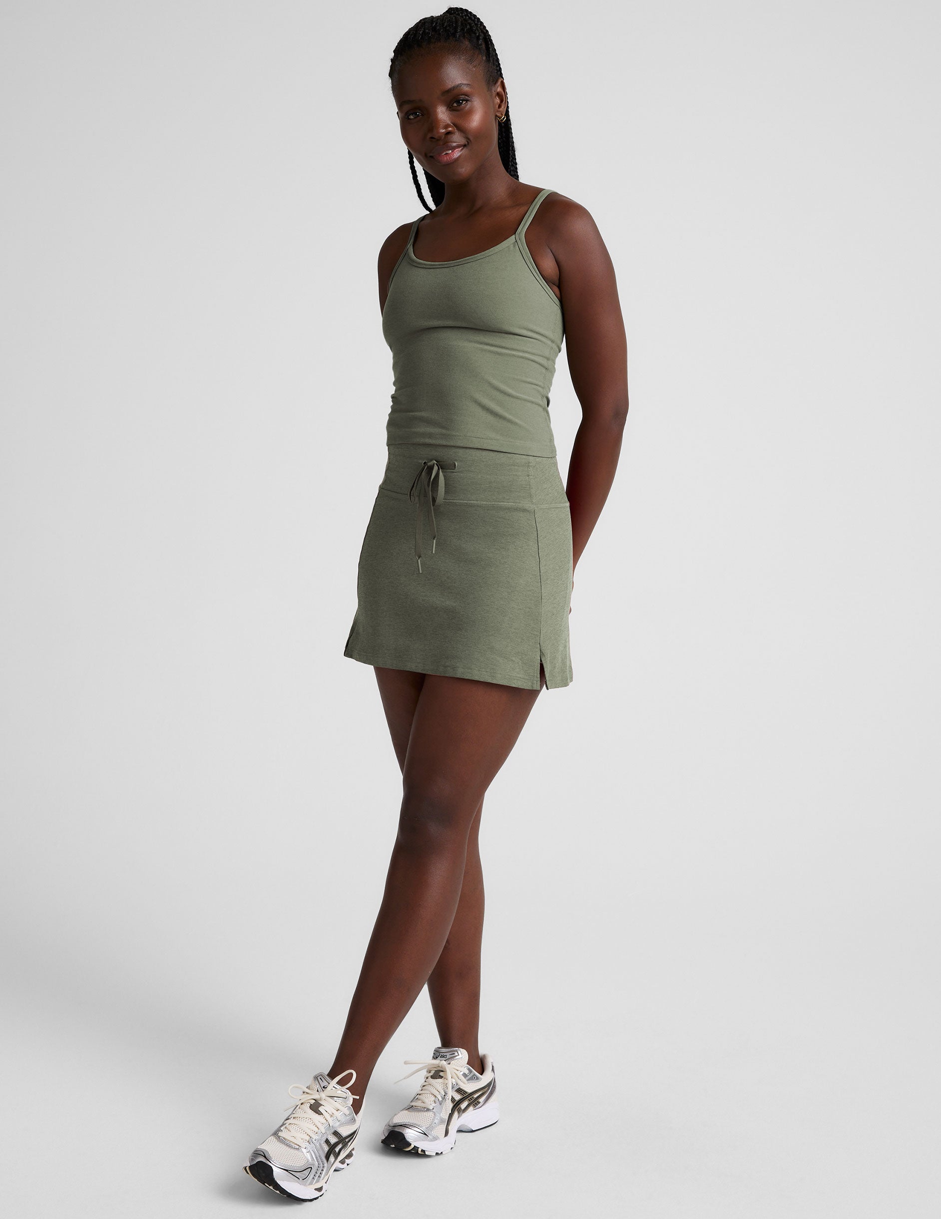 green mini skirt with a drawstring at waistband and pockets.
