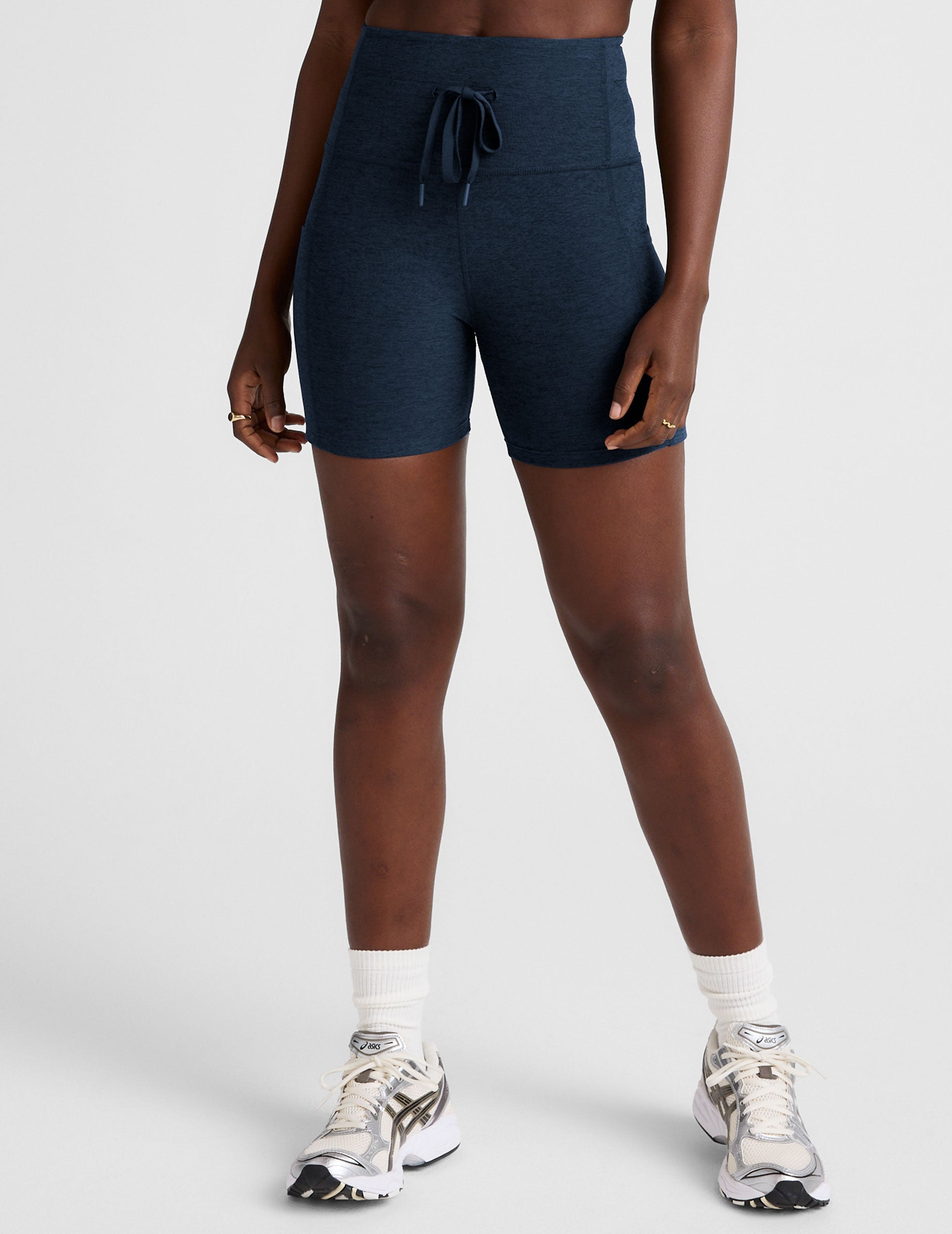 blue high-waisted 5" inseam biker shorts with pockets and a drawstring at waistband.