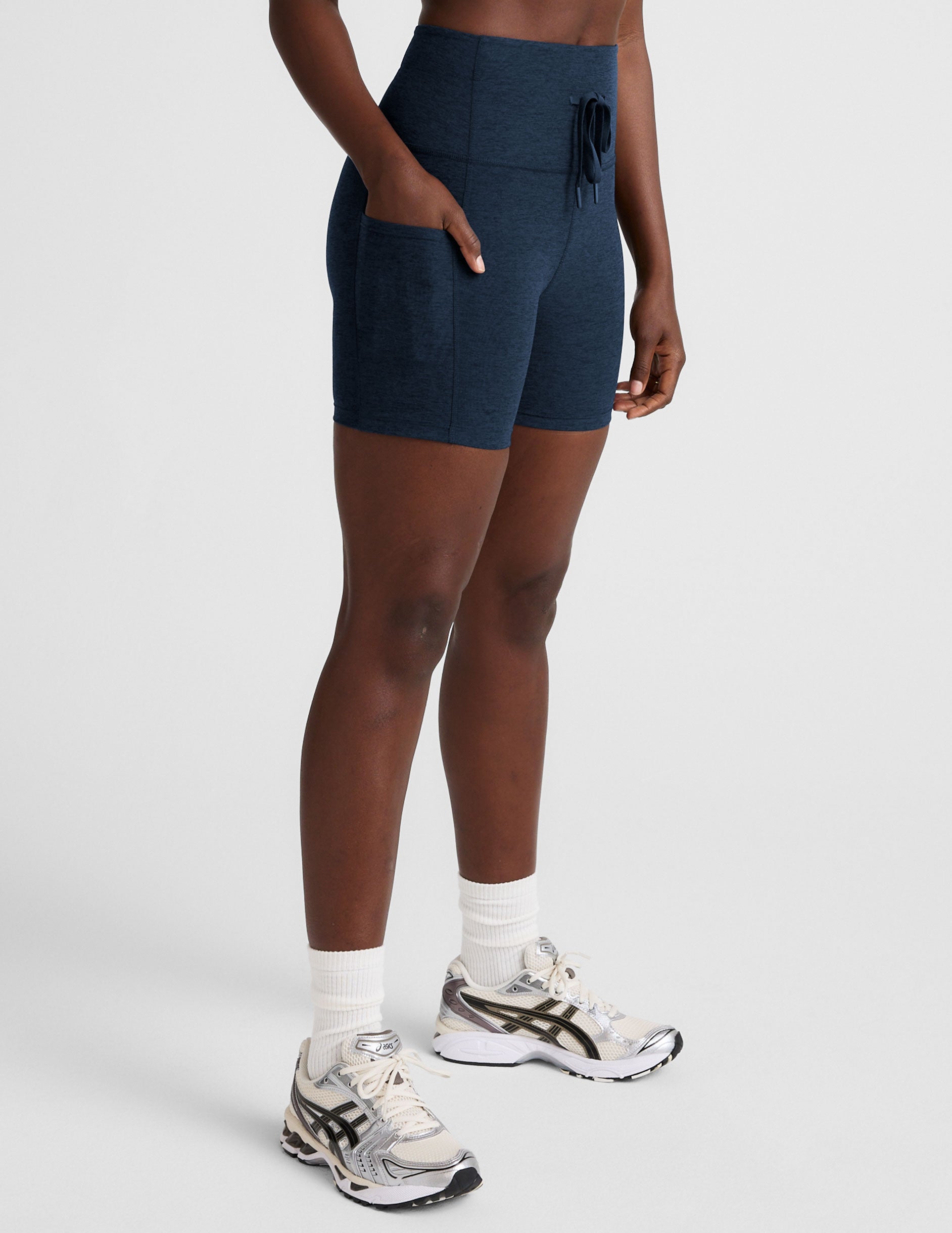 blue high-waisted 5" inseam biker shorts with pockets and a drawstring at waistband.