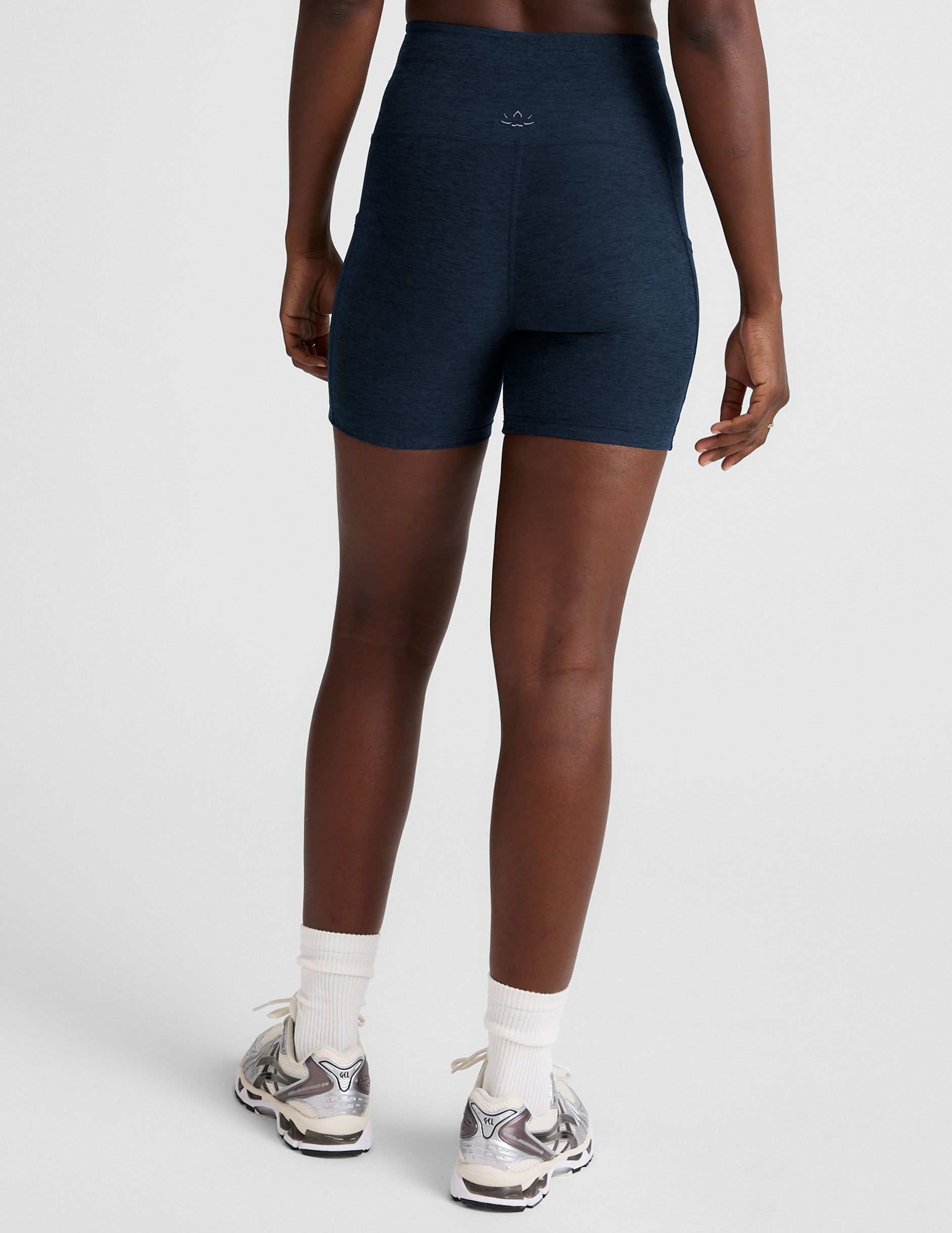 blue high-waisted 5" inseam biker shorts with pockets and a drawstring at waistband.