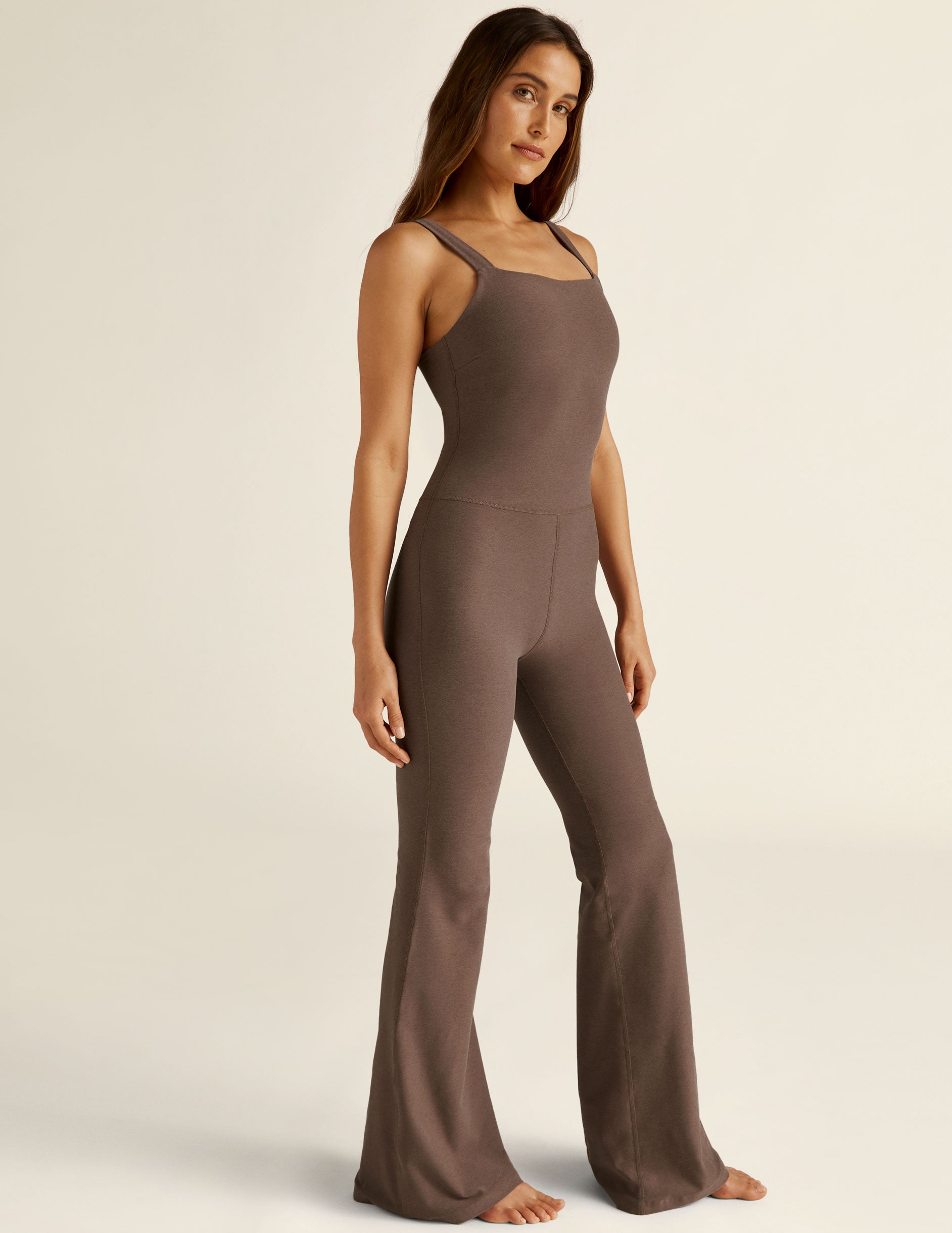 brown jumpsuit with flare bottoms and thin straps. 