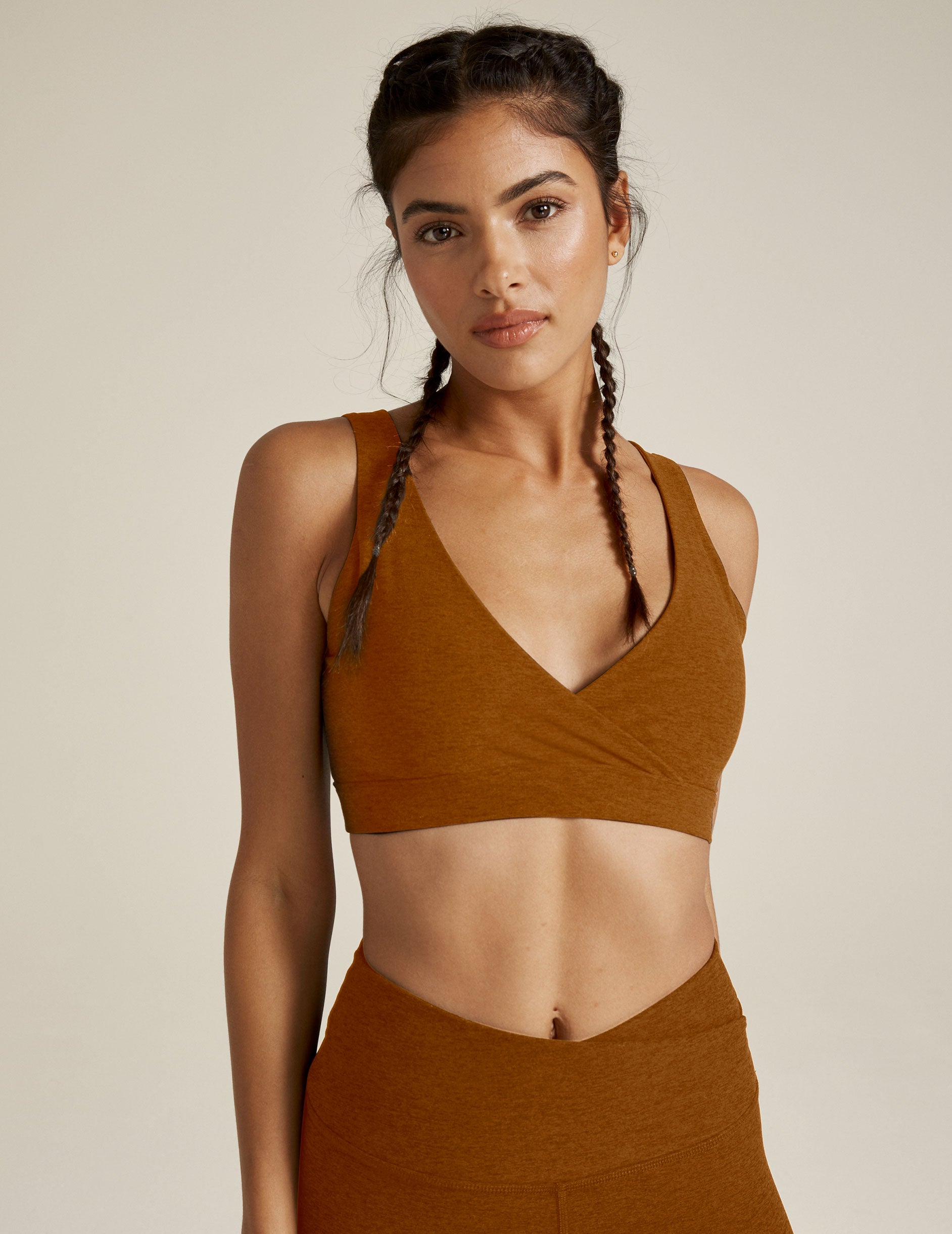 brown bra top with overlapping front panels and a deep v-neck in the back. 