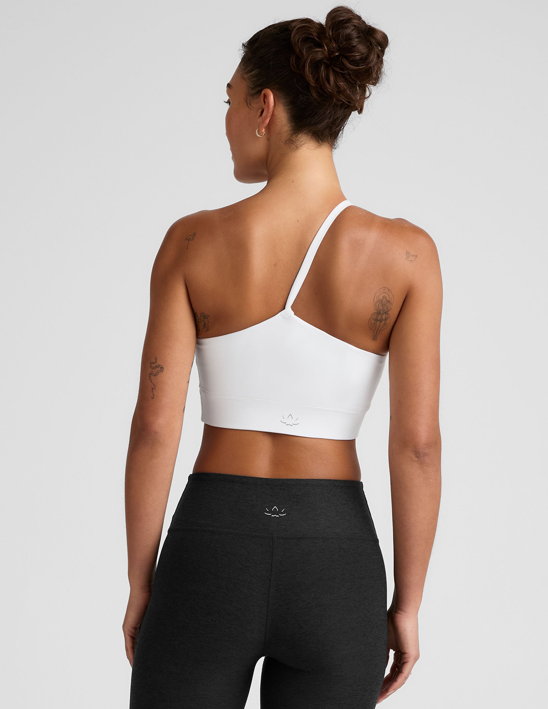 white long line length bra with a one strap detail and open back.