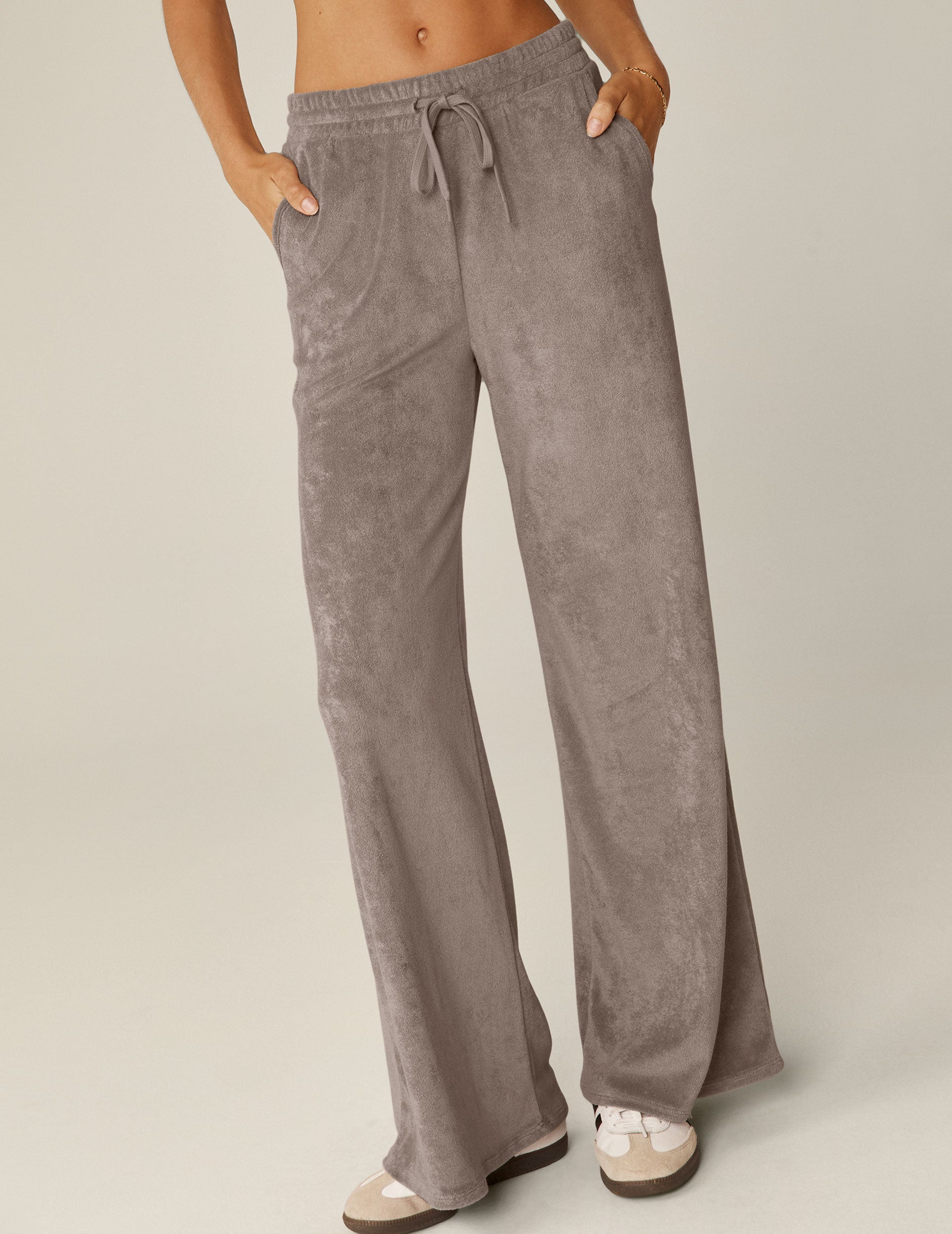 brown terry fabric wide leg pants with a drawstring at the waistband.