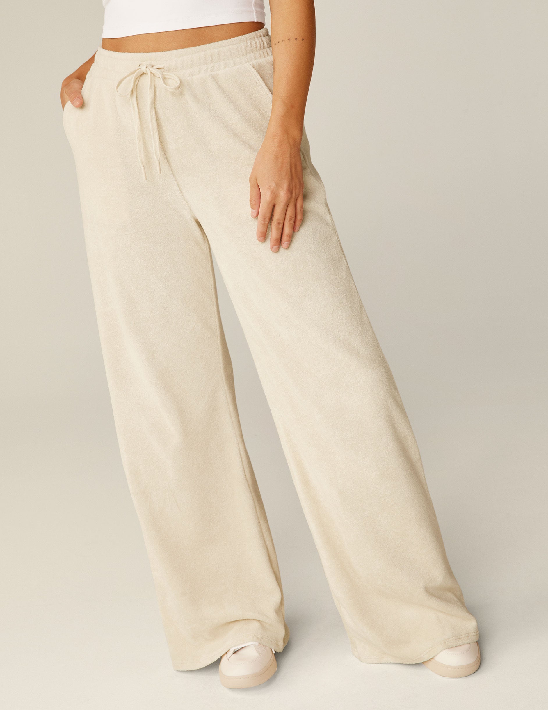 white terry fabric wide leg pants with a drawstring at the waistband.