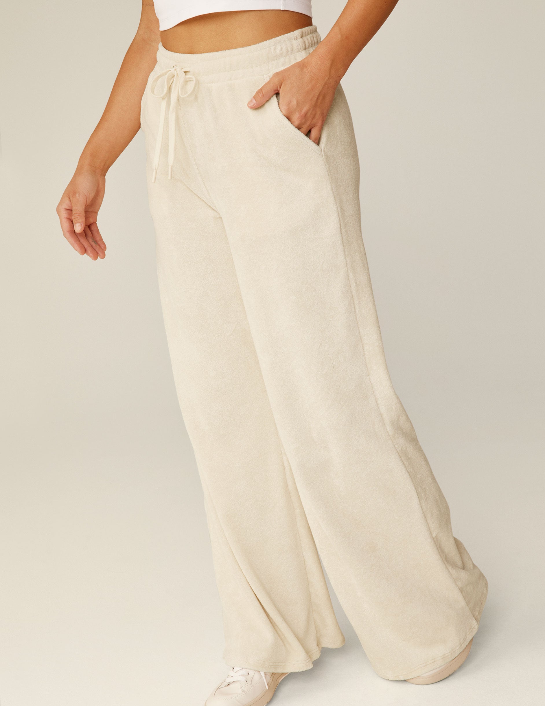 white terry fabric wide leg pants with a drawstring at the waistband.