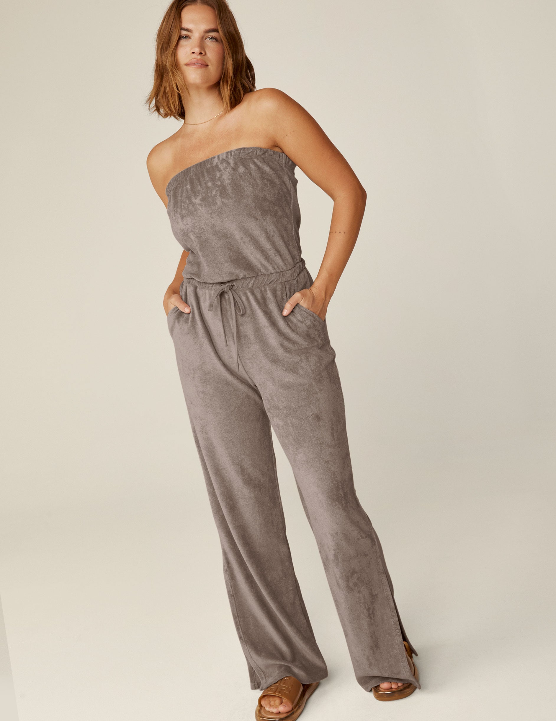 brown strapless terry jumpsuit with a drawstring at the waistband.