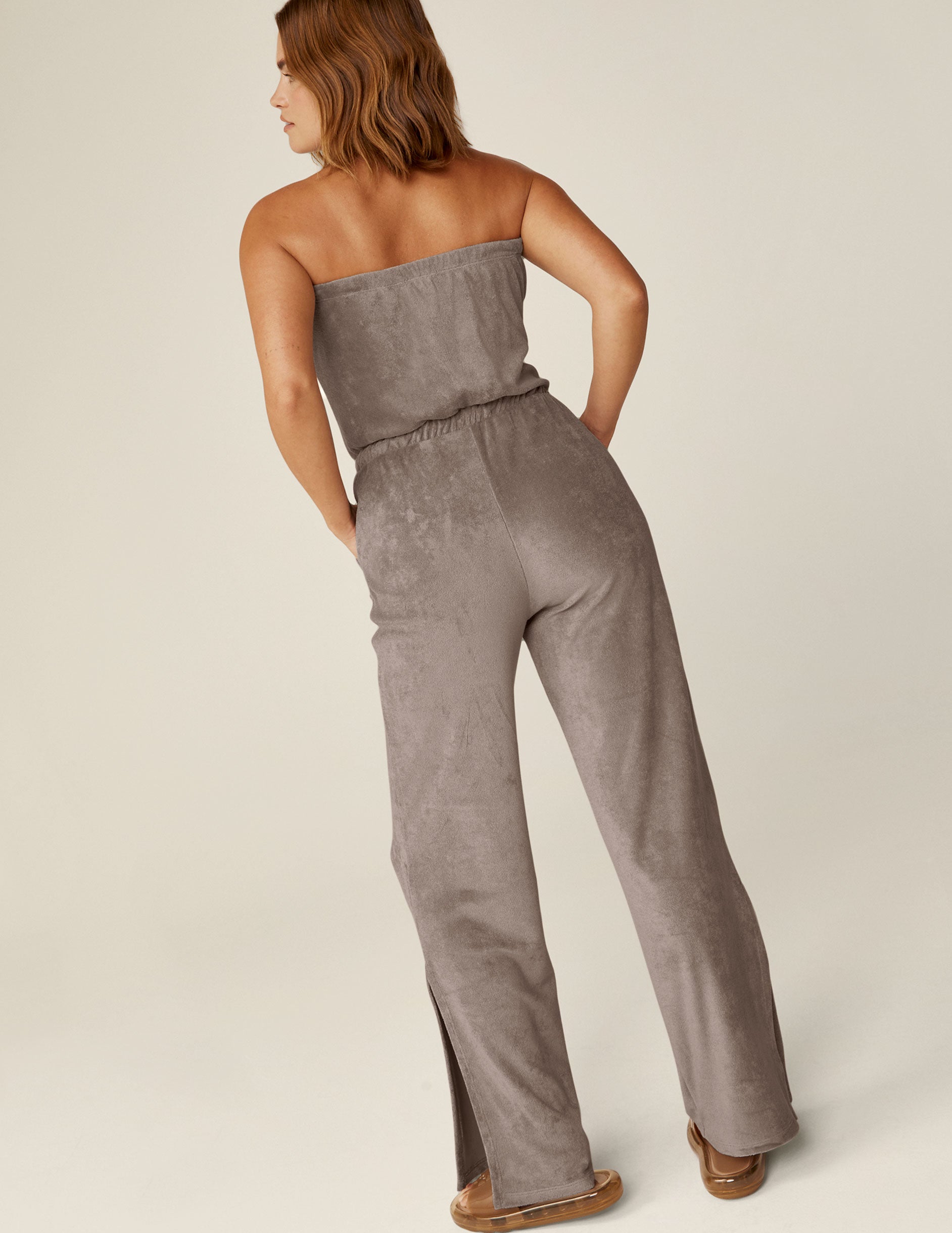 brown strapless terry jumpsuit with a drawstring at the waistband.