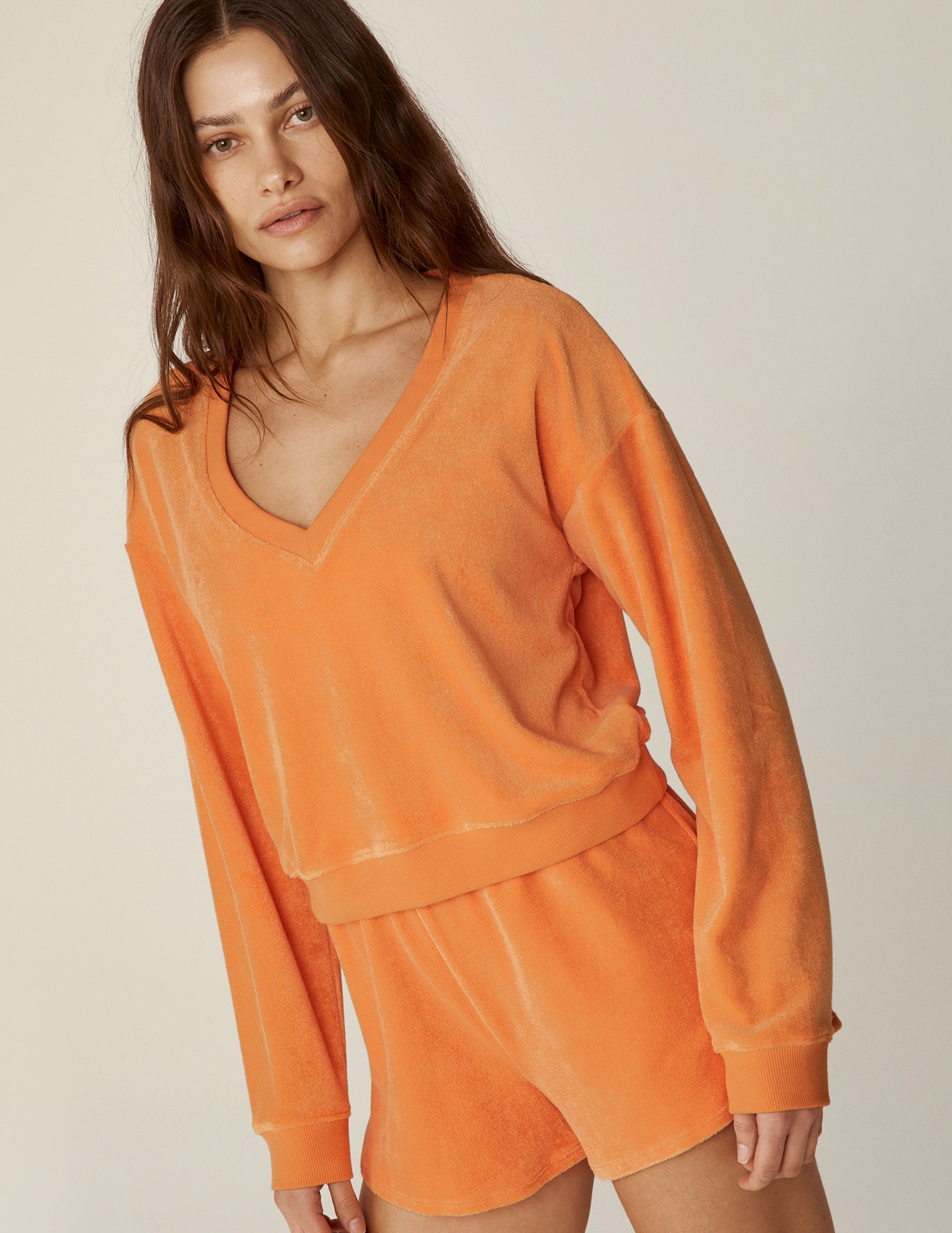 orange terry fabric v-neck long sleeve pullover.  