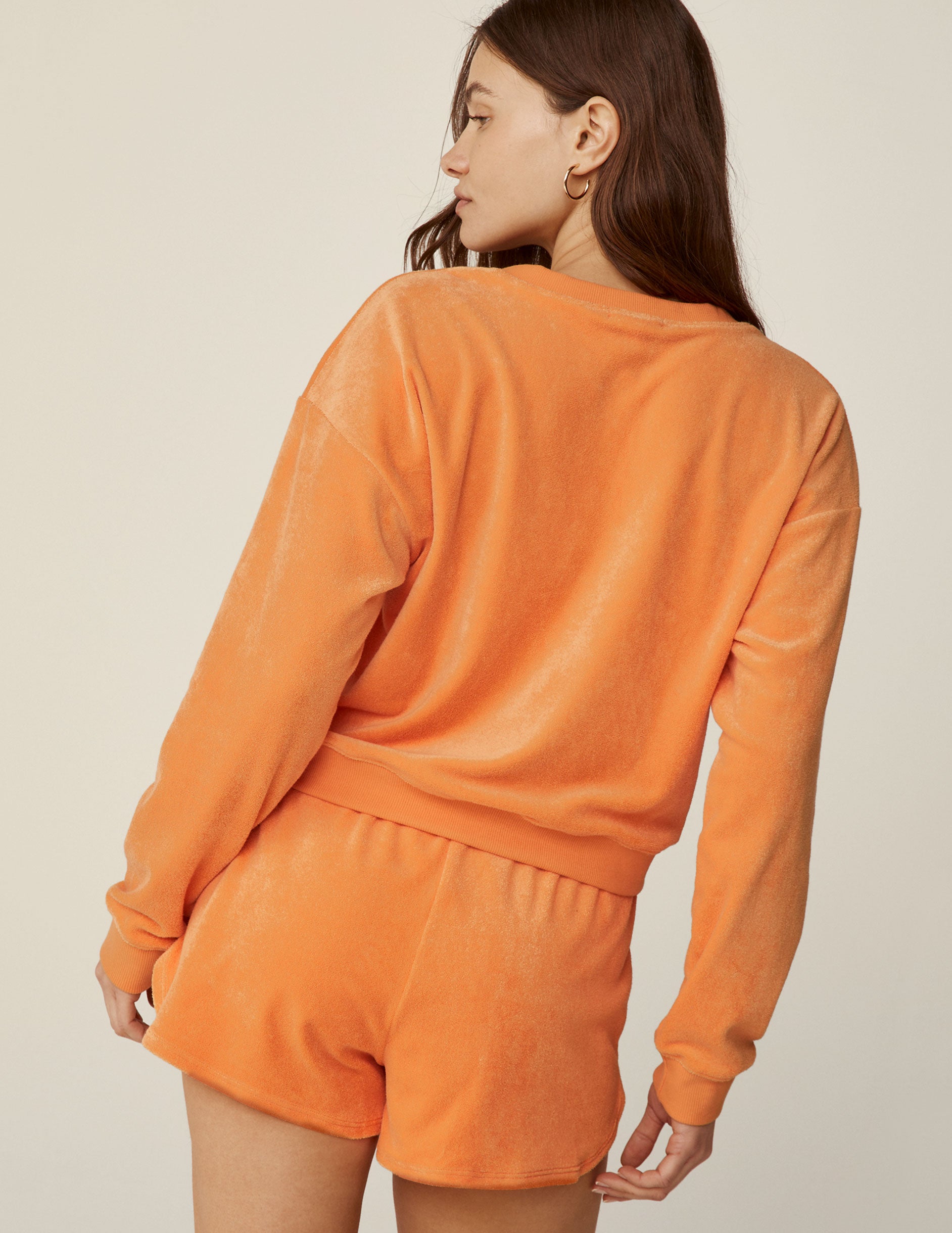 orange terry fabric v-neck long sleeve pullover.
