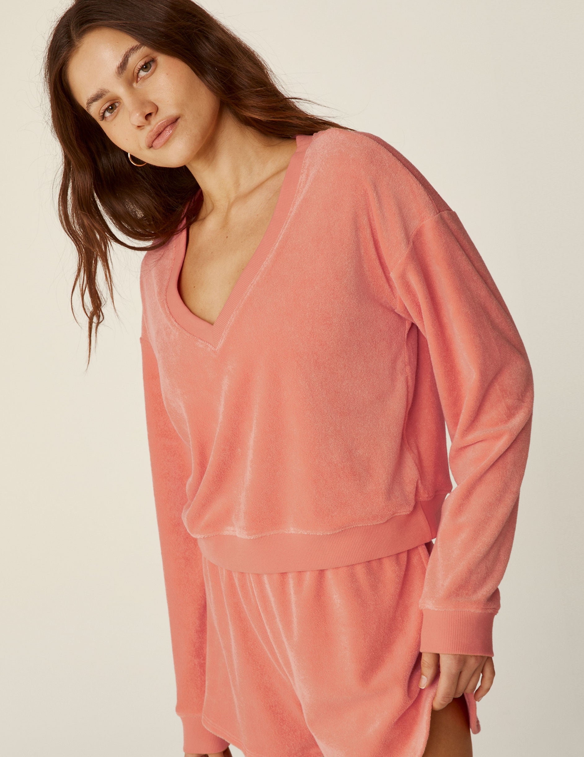 pink v-neck terry fabric long sleeve pullover.