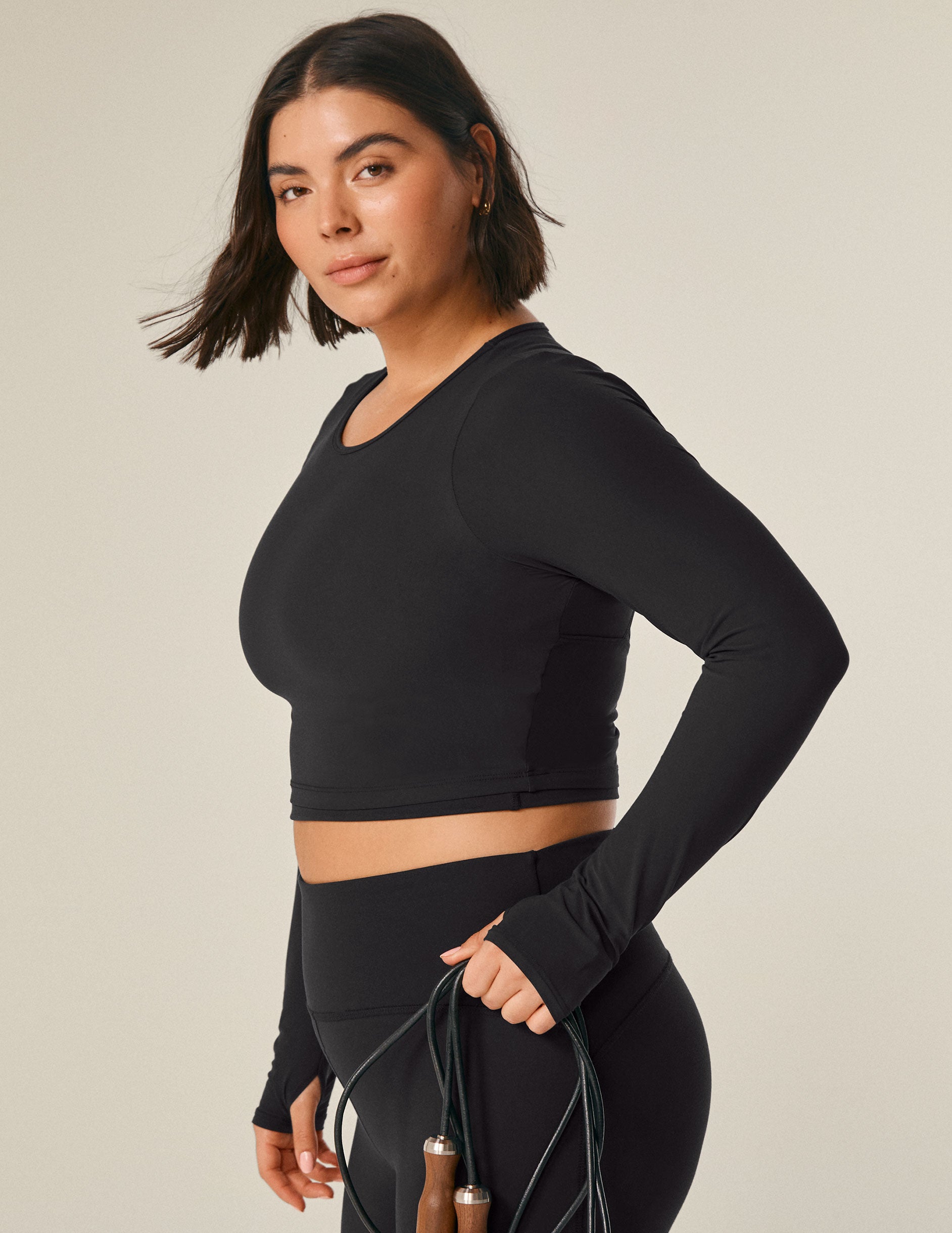 black long sleeve cropped top with an open back detail.