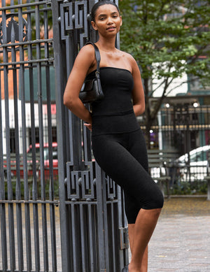 woman wearing a tube top and black pedal pushers. 