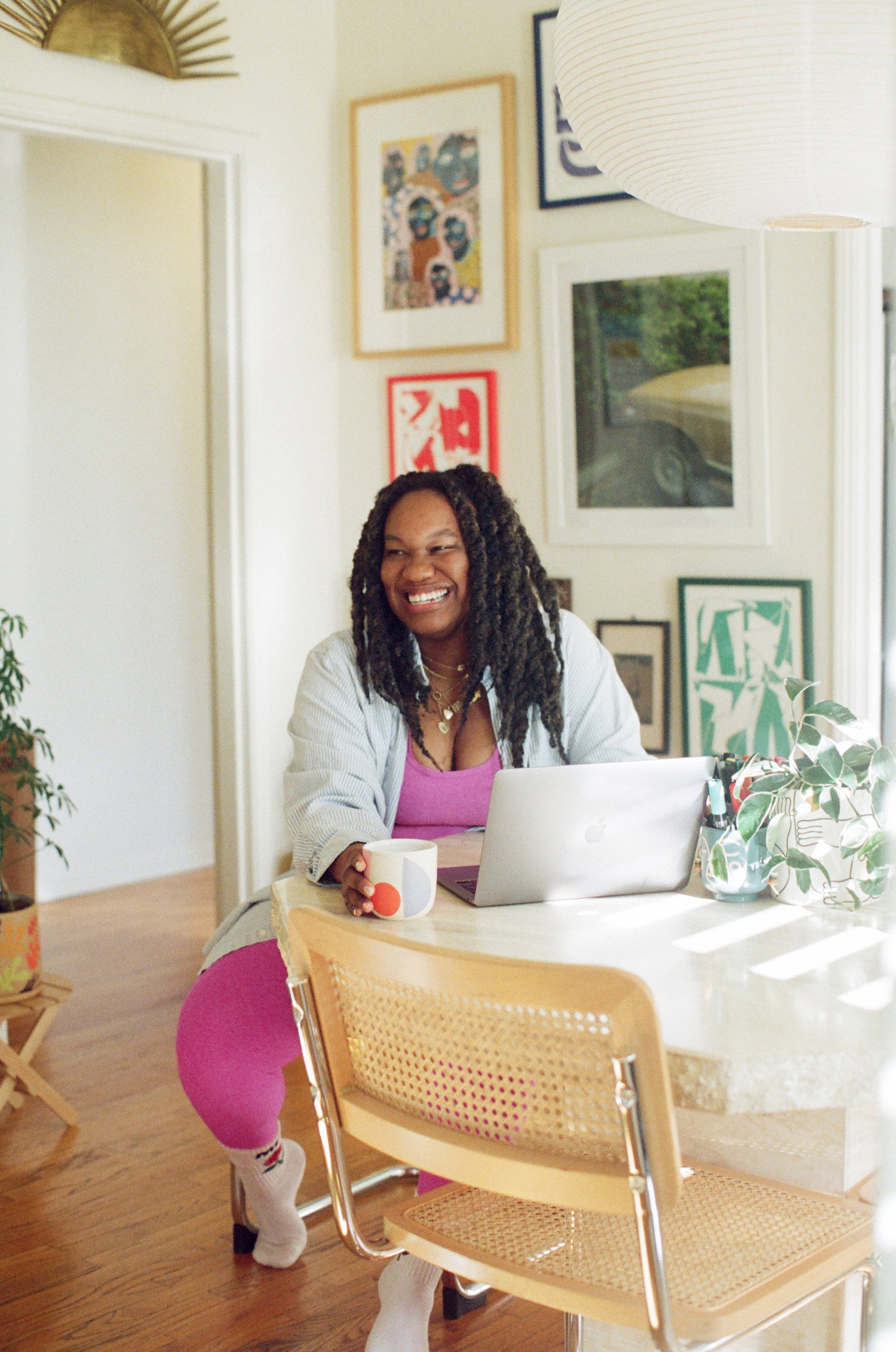 Kristina sitting at a table wearing a Vivid Plum Spacedye set