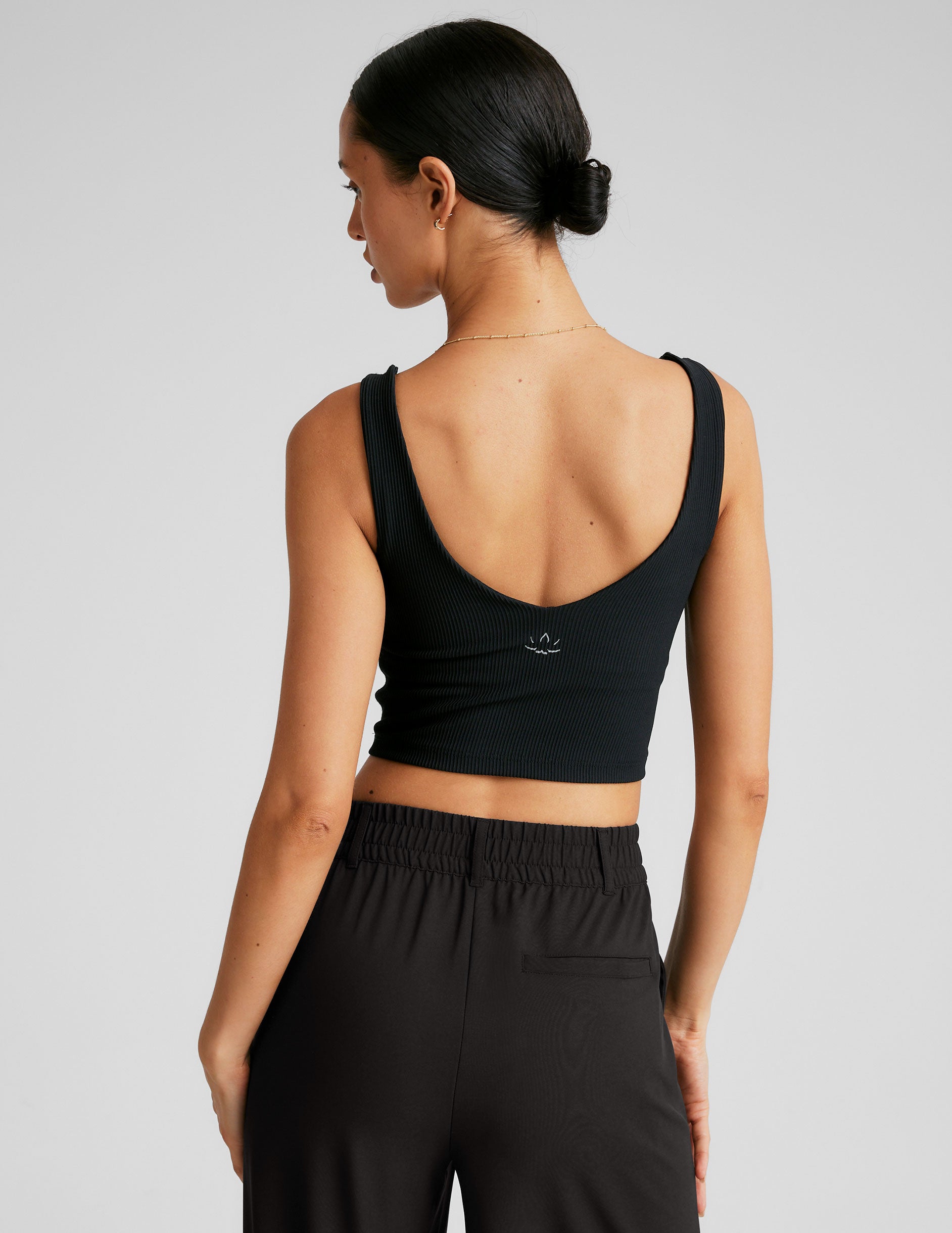 black ribbed cropped tank with a front and back v neckline. 