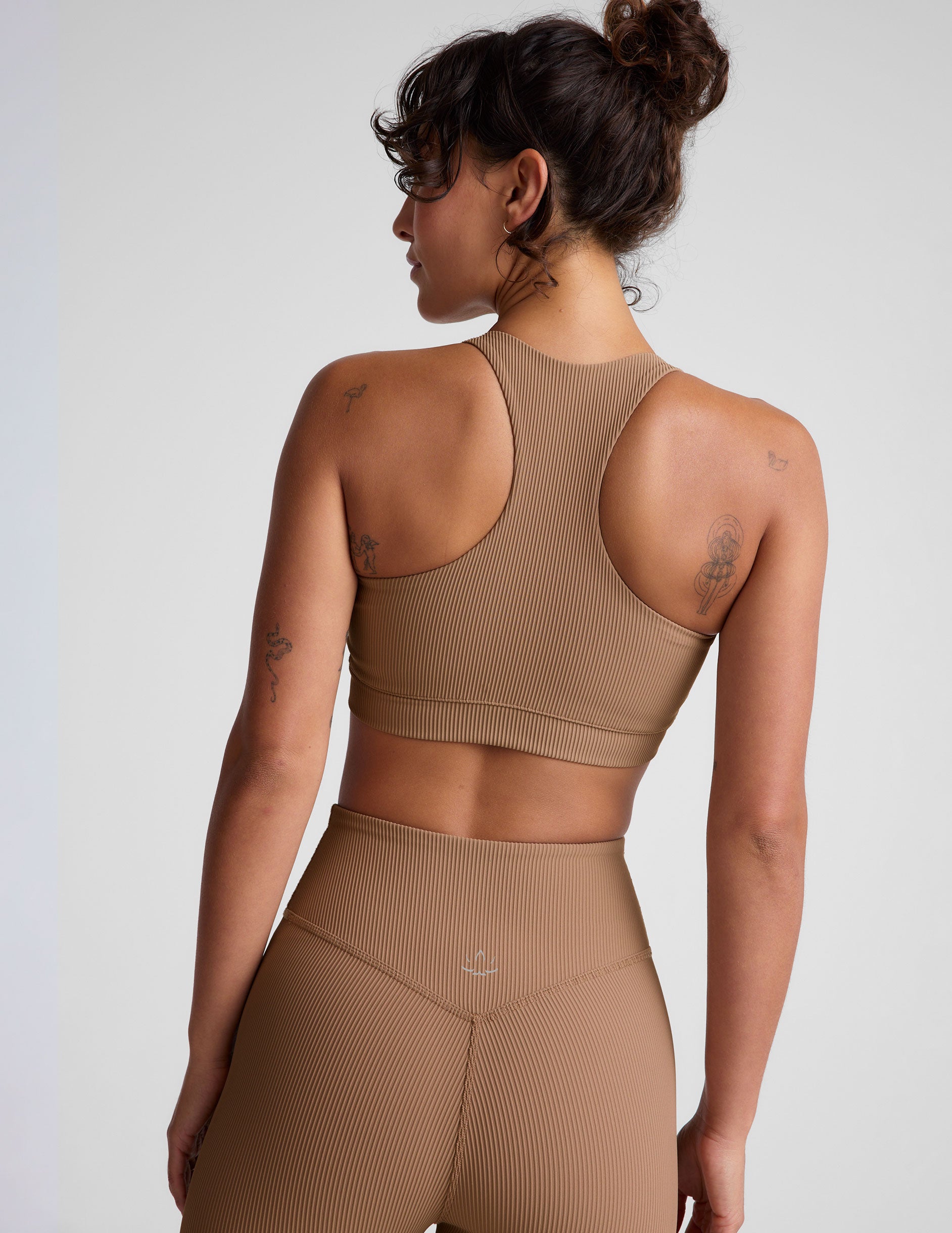 brown ribbed racerback bra with overlapping hemband detail and a scoop neckline.