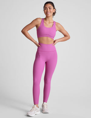 pink medium support racerback bra with a scoop neckline​, overlapping hemband detail​, is lined with performance lining and powermesh in between​, and has removable bra pads​. 