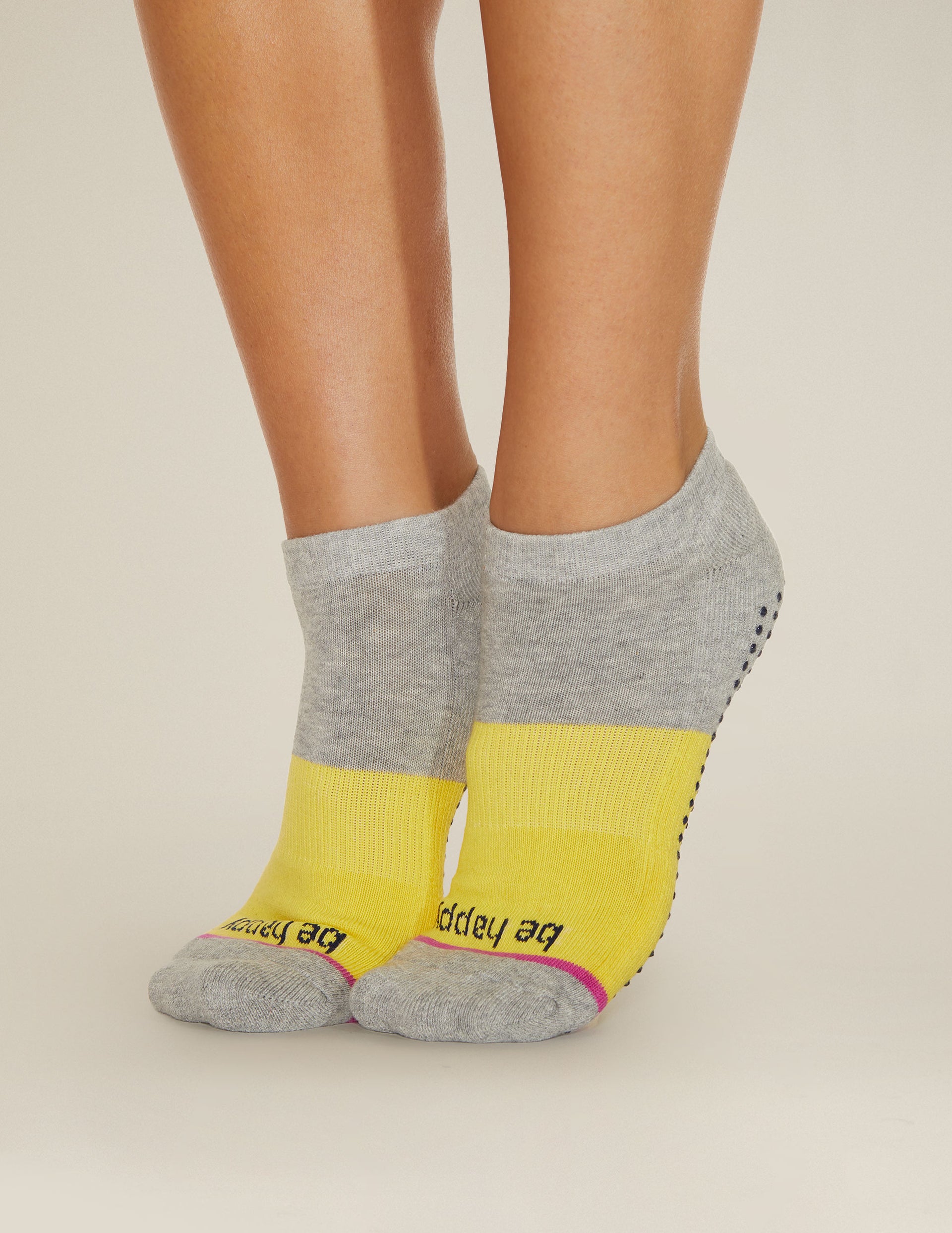 grey and yellow ankle socks with the mantra be happy printed.