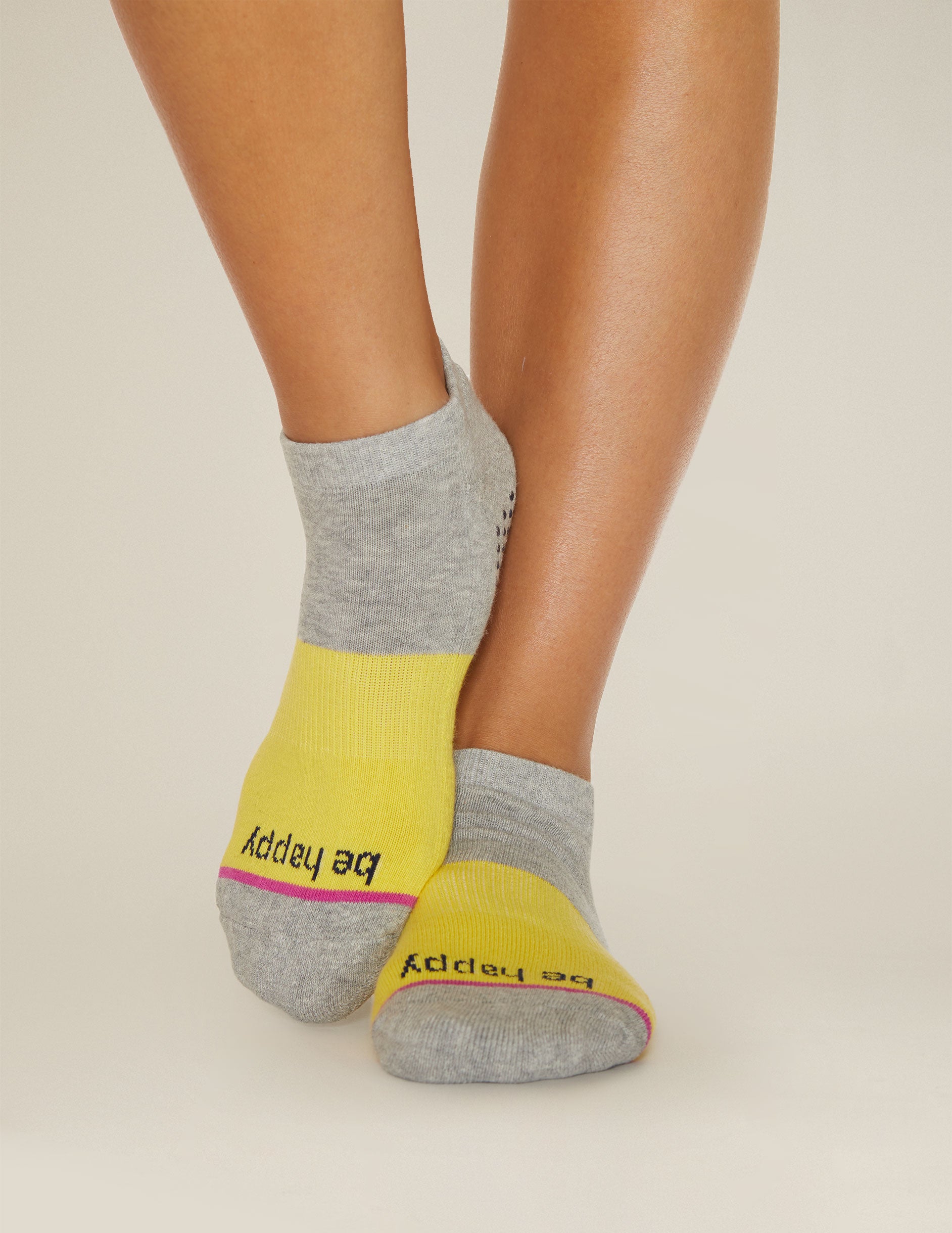 grey and yellow ankle socks with the mantra be happy printed. 