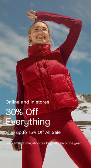 Woman in a red puffer jacket and pants standing outdoors with promotional text overlay.