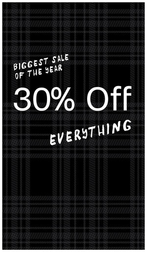 Black plaid fabric with white text announcing a 30% off sale.