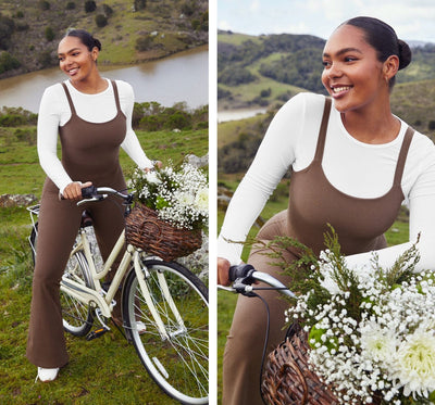 model is wearing a brown flare jumpsuit. 