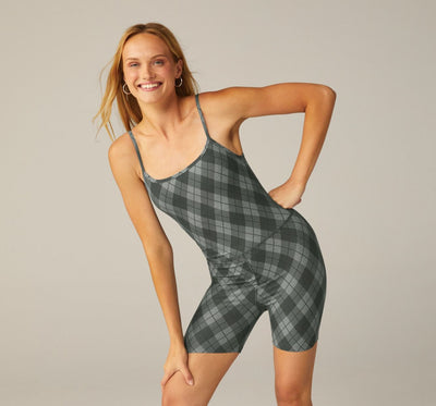 model is wearing a grey argyle printed jumpsuit. 